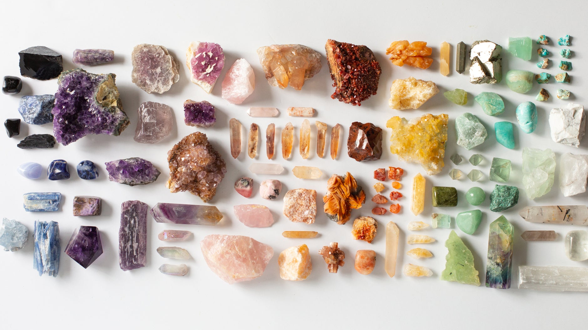 Large flat lay of colorful healing crystals and gemstones, featuring raw and polished varieties like amethyst, citrine, rose quartz, and fluorite — ideal for collectors, crystal healing, energy work, and spiritual shoppers.