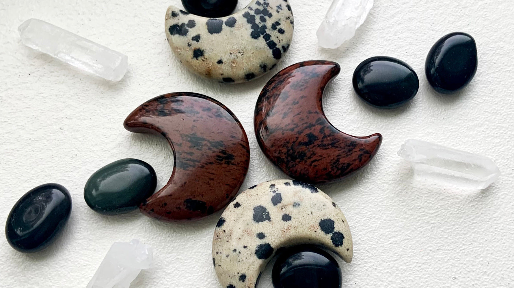 A crystal grid for energetic protection made with Mahogany Obsidian, Black Obsidian, Dalmatian Jasper, and Clear Quartz points — the perfect banner for our blog post on the crystal healing properties of Obsidian.