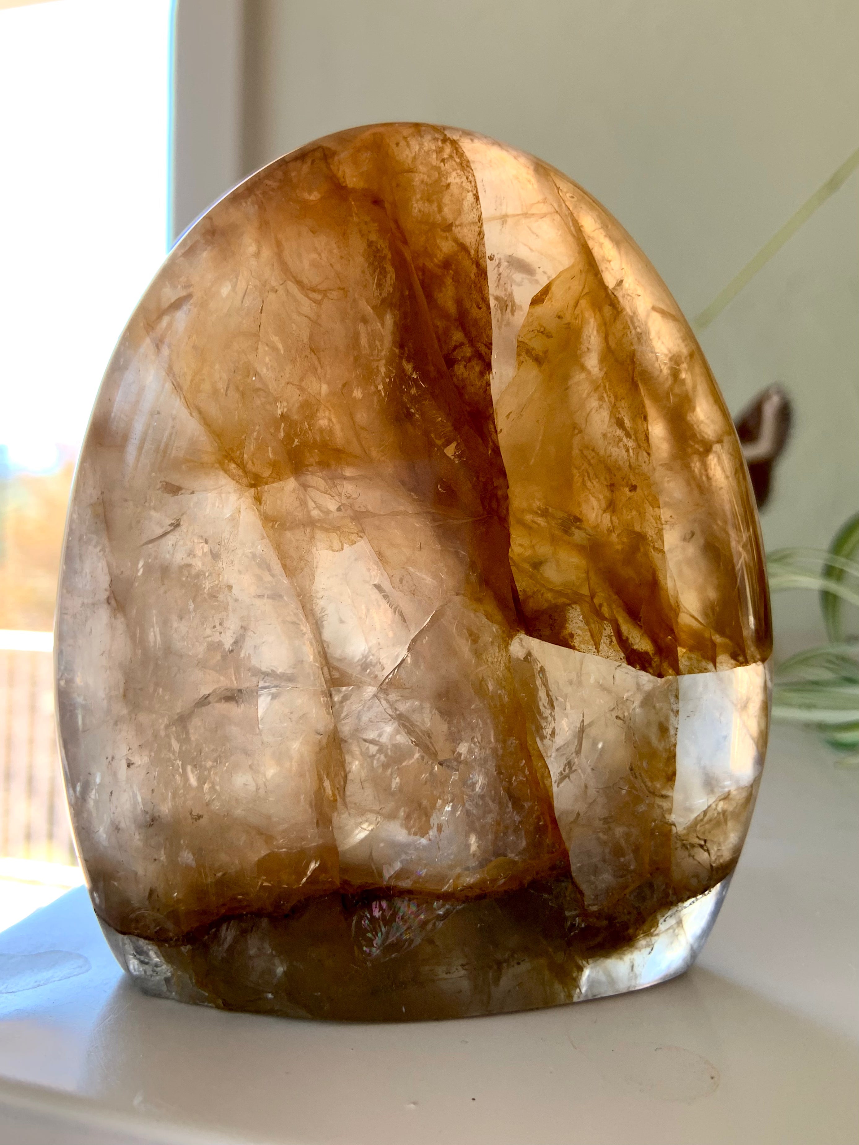 High-quality Golden Healer Quartz freeform carving with luminous golden tones, natural transparency, and sacred crystal patterns, featured in our Golden Healer Quartz collection.