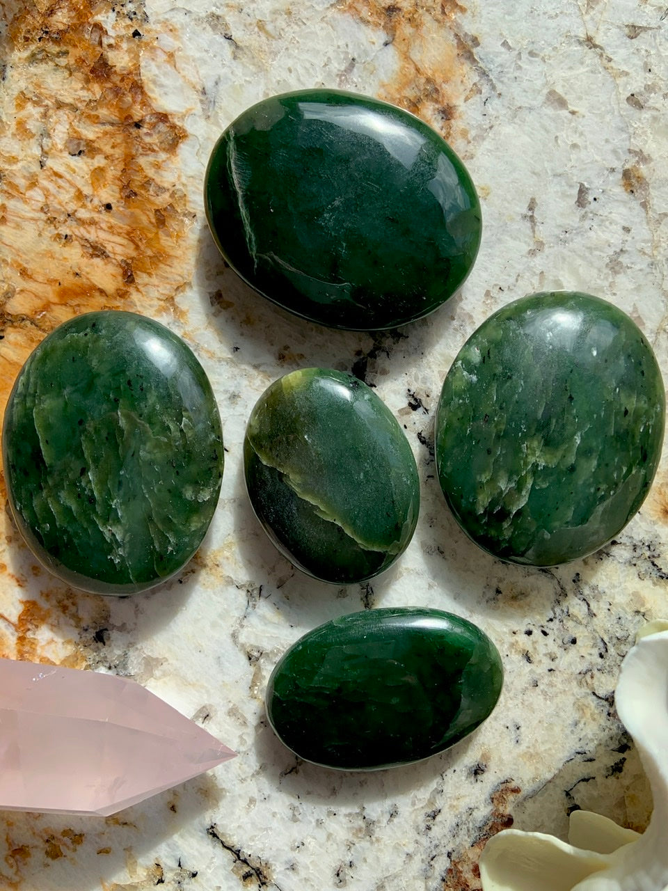 Nephrite Jade palm stones in rich green hues — smooth polished crystals for grounding energy, protection, and heart chakra healing.