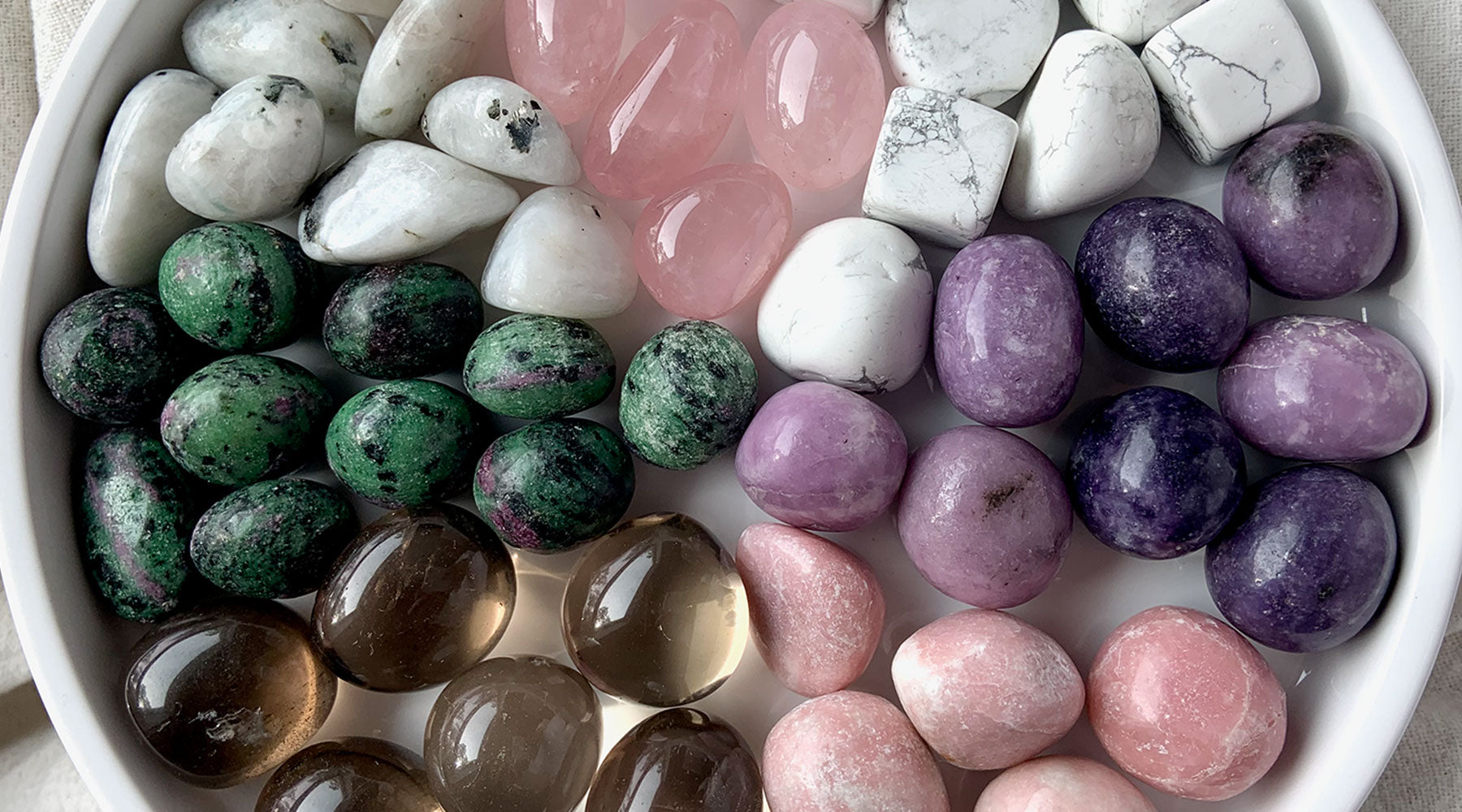 Healing crystals for grief collection with rose quartz, smoky quartz, pink opal, lepidolite, howlite, rainbow moonstone, and ruby in zoisite for comfort and support