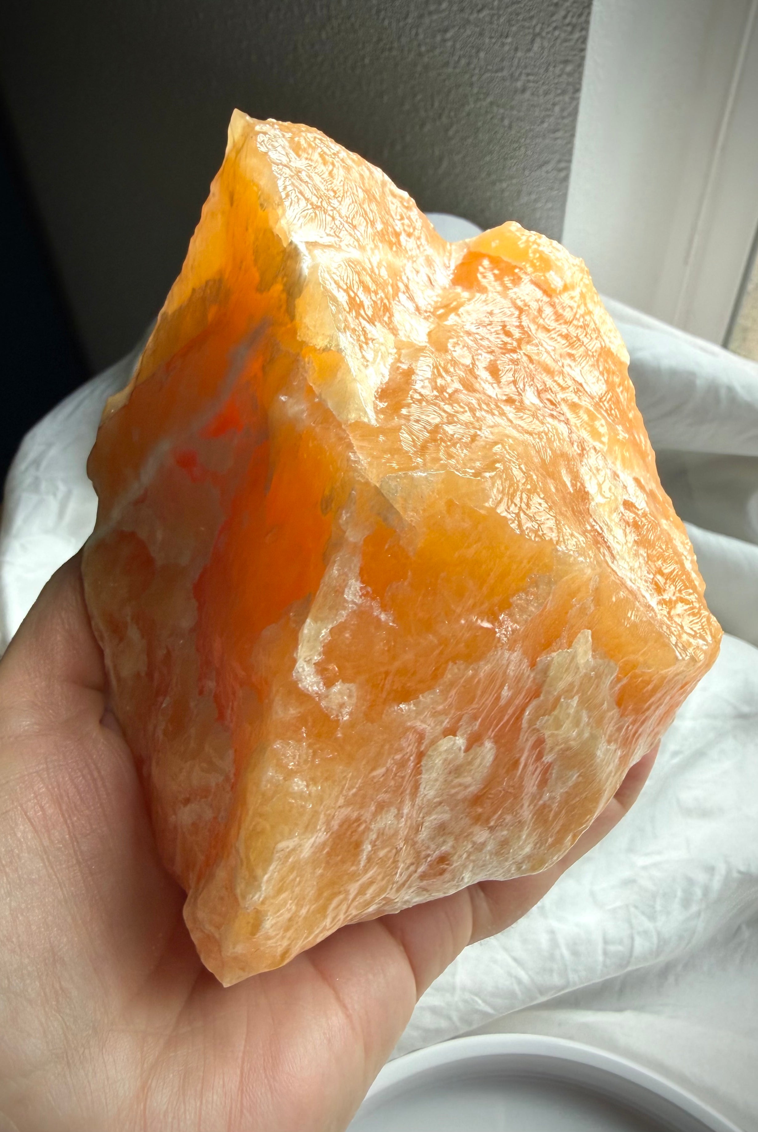 Orange Calcite crystal from Mexico featuring creamy white mineral patterns and rich orange coloration