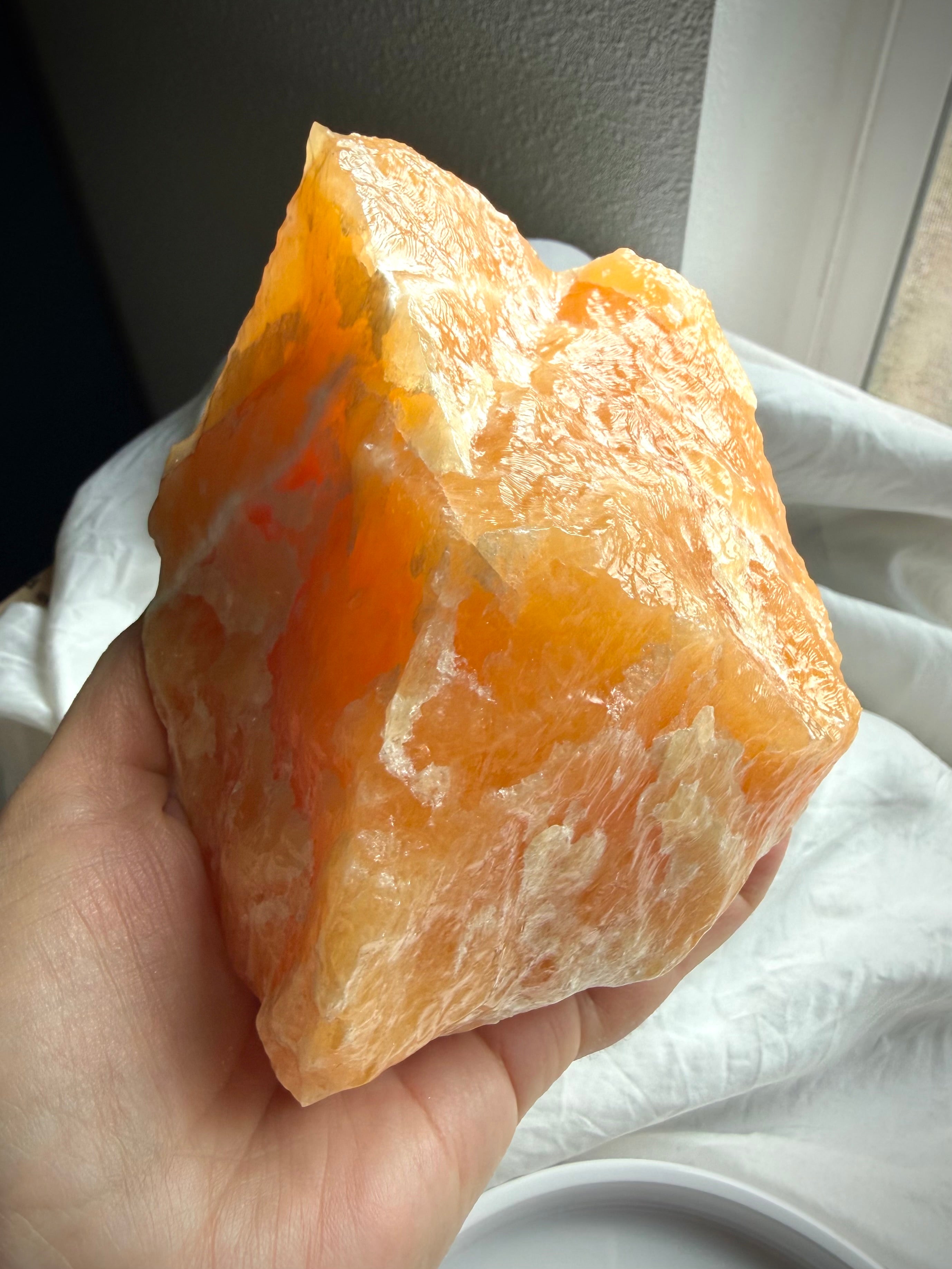 Orange Calcite crystal from Mexico featuring creamy white mineral patterns and rich orange coloration