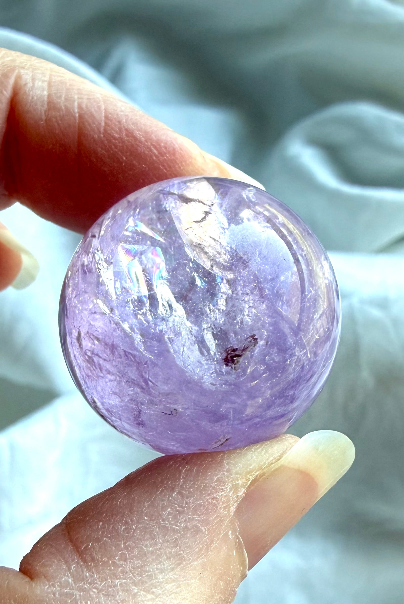 smoky amethyst mini sphere with natural inclusions and polished surface