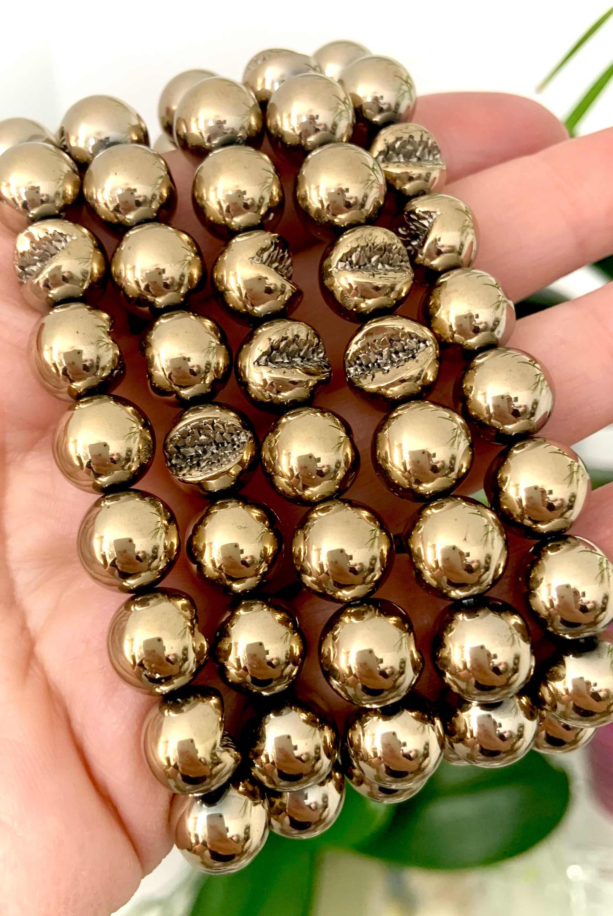 Close-up of round Pyrite beads with natural geode-like texture — crystal of confidence, abundance, and spiritual protection.