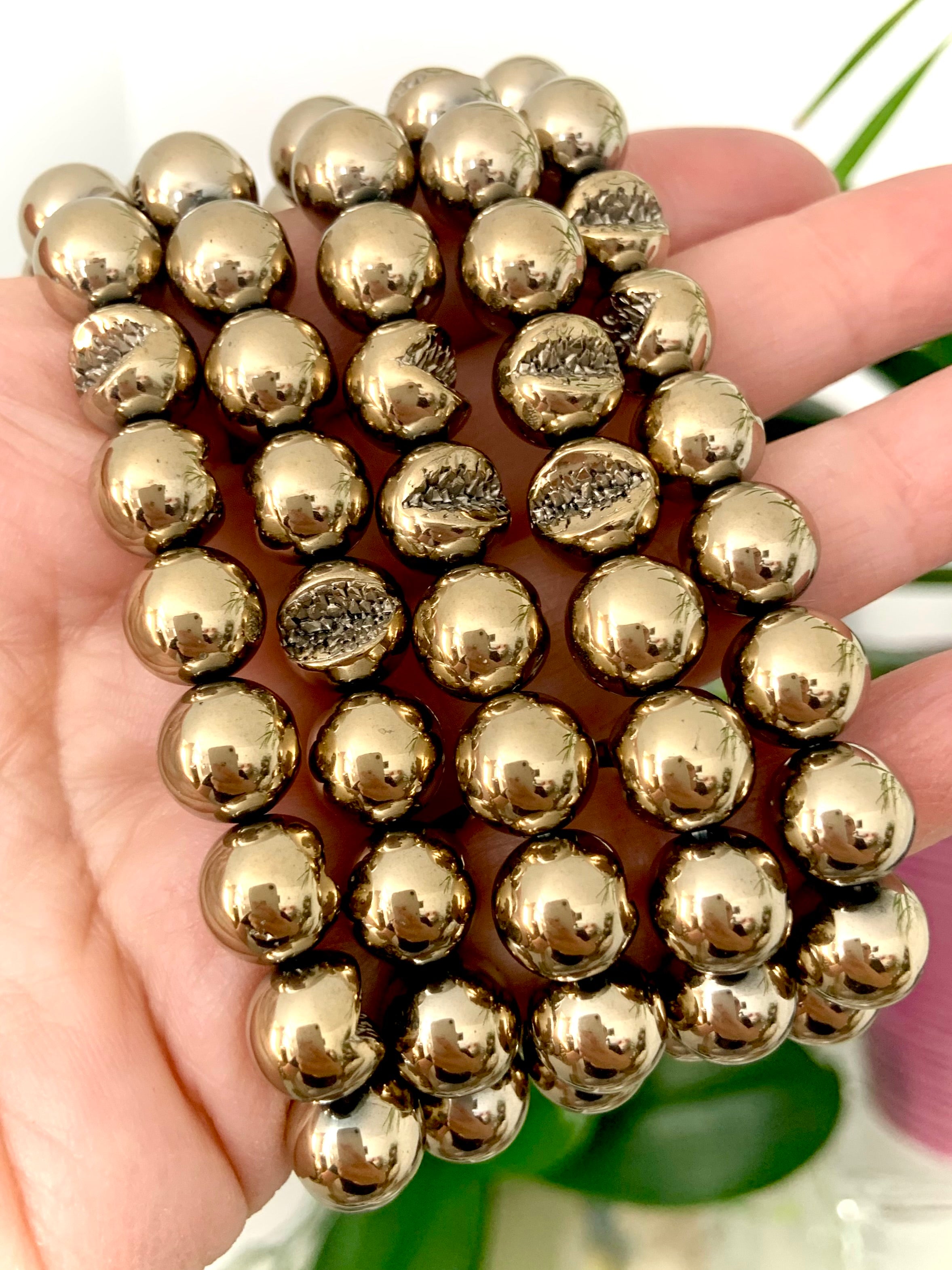 Close-up of round Pyrite beads with natural geode-like texture — crystal of confidence, abundance, and spiritual protection.