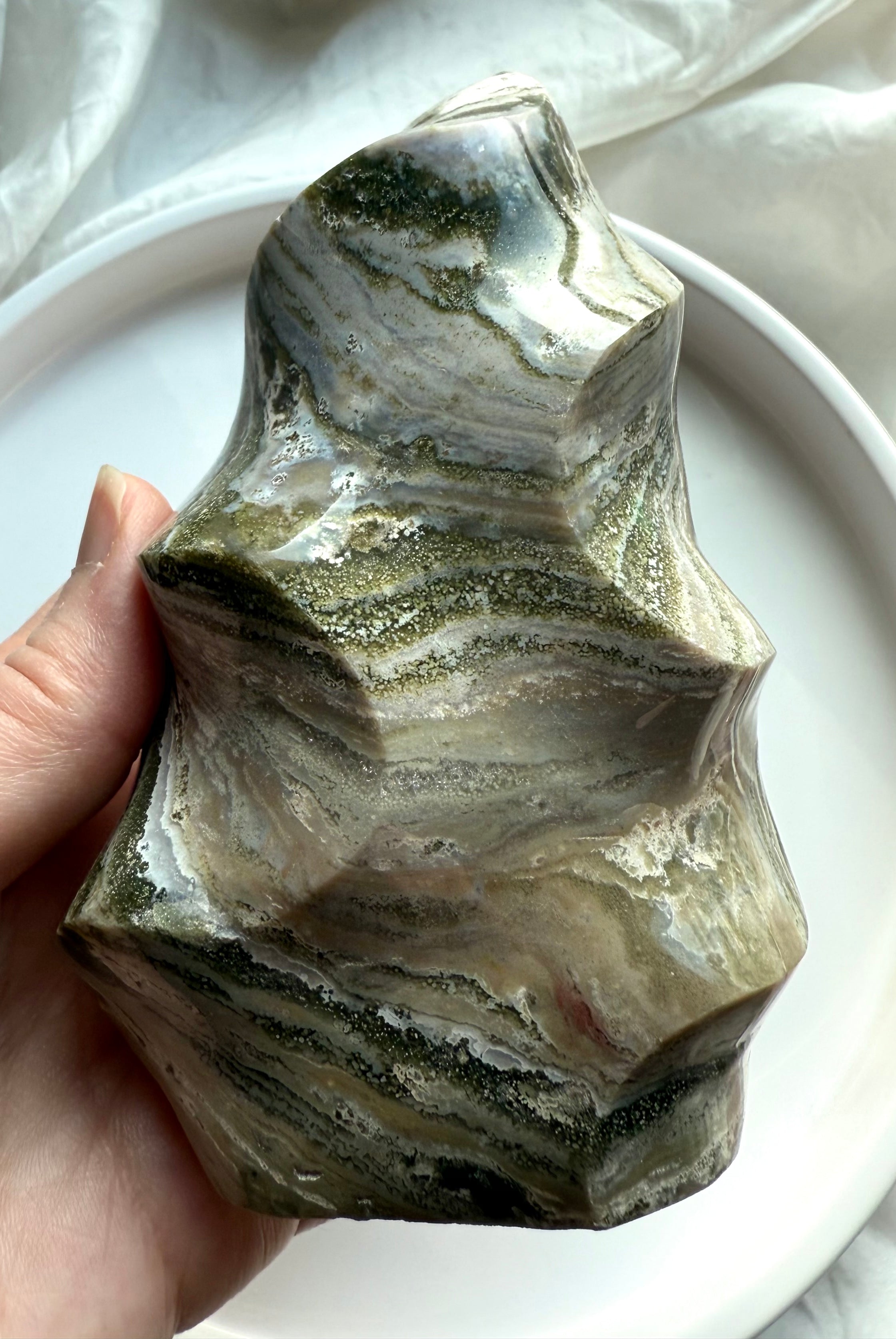 Polished Green Ocean Jasper flame with flowing banded layers and organic curves, healing stone for grounding and balance.