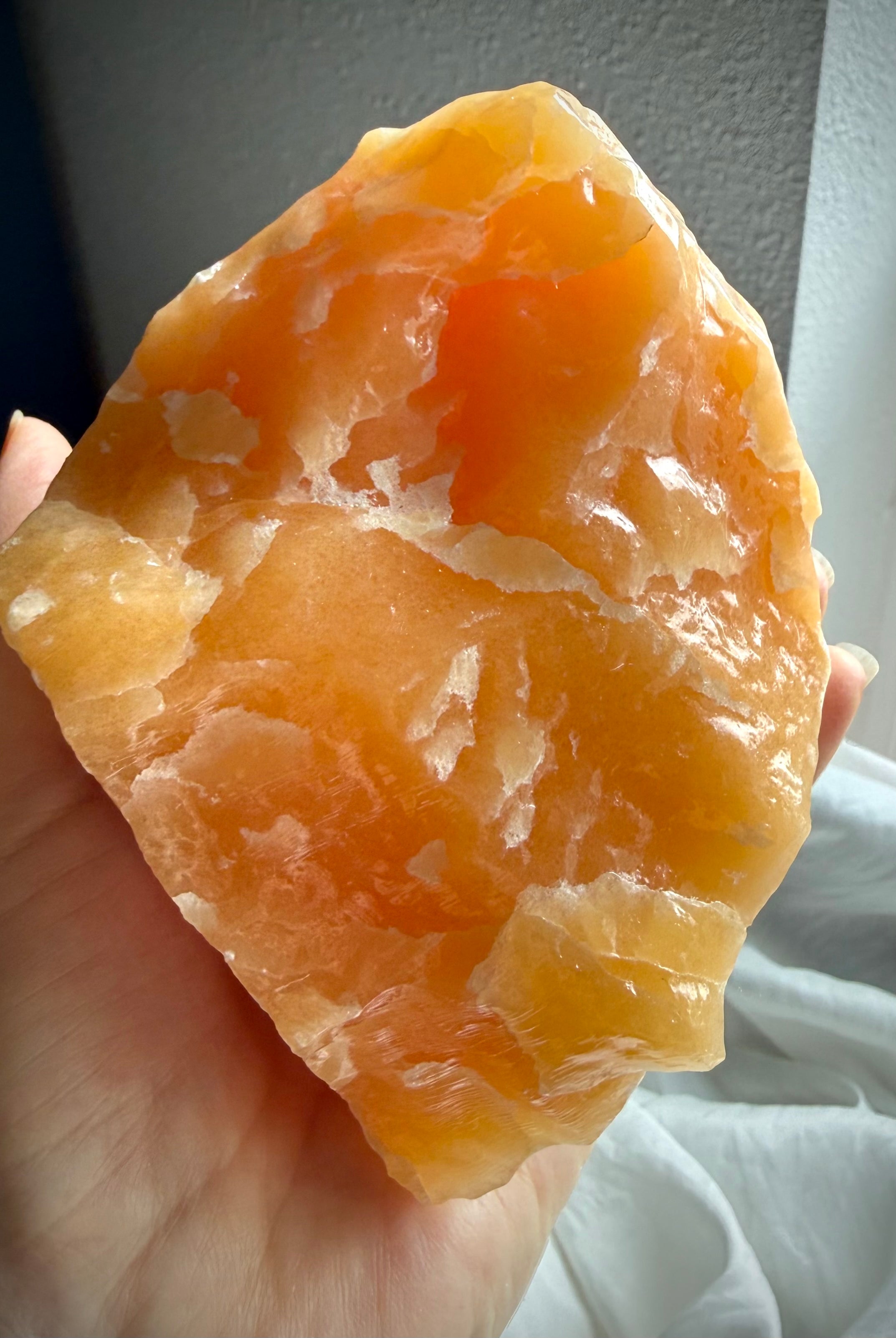 Natural Orange Calcite statement crystal with raw organic shape and glowing translucent interior