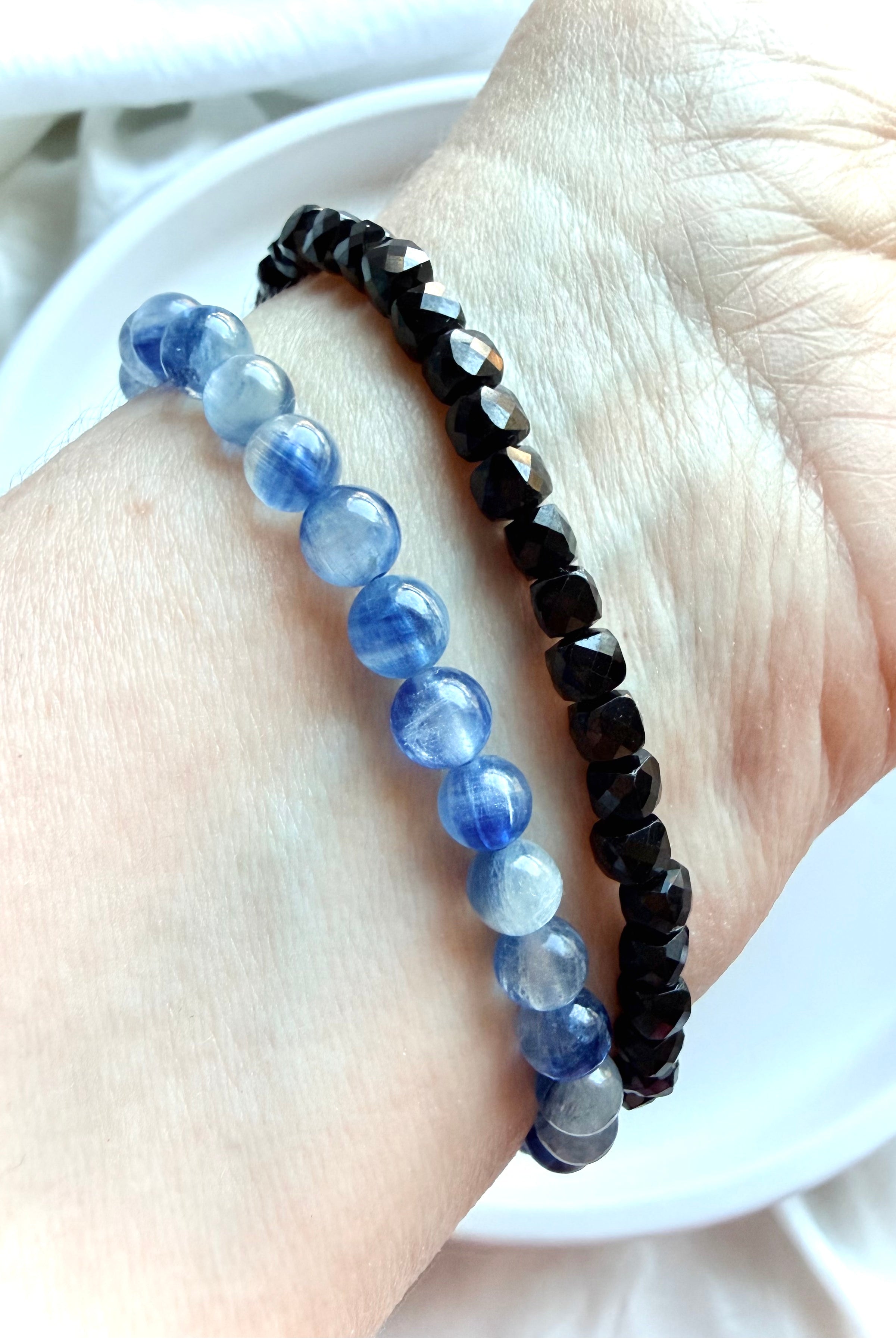 Blue Kyanite bracelet stacked with a Faceted Black Spinel bracelet for crystal jewelry styling