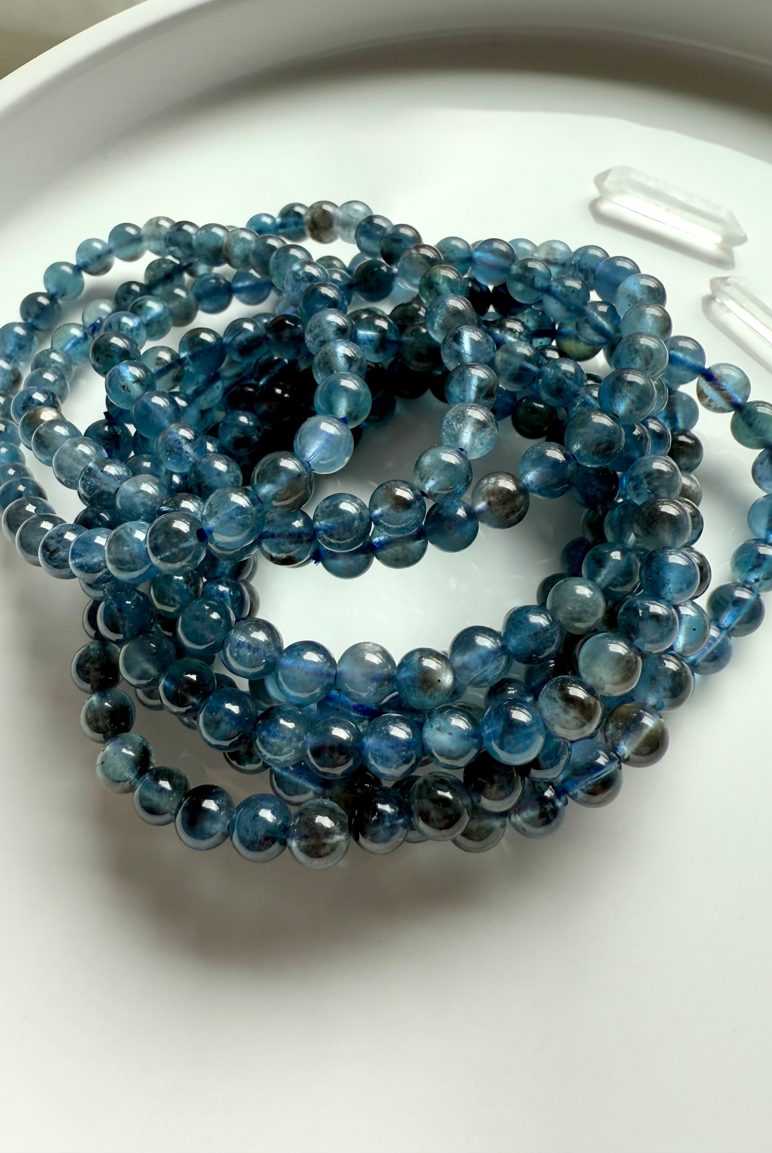 Deep blue Aquamarine Bracelets aka Devil Aquamarine photographed in natural light on a white plate