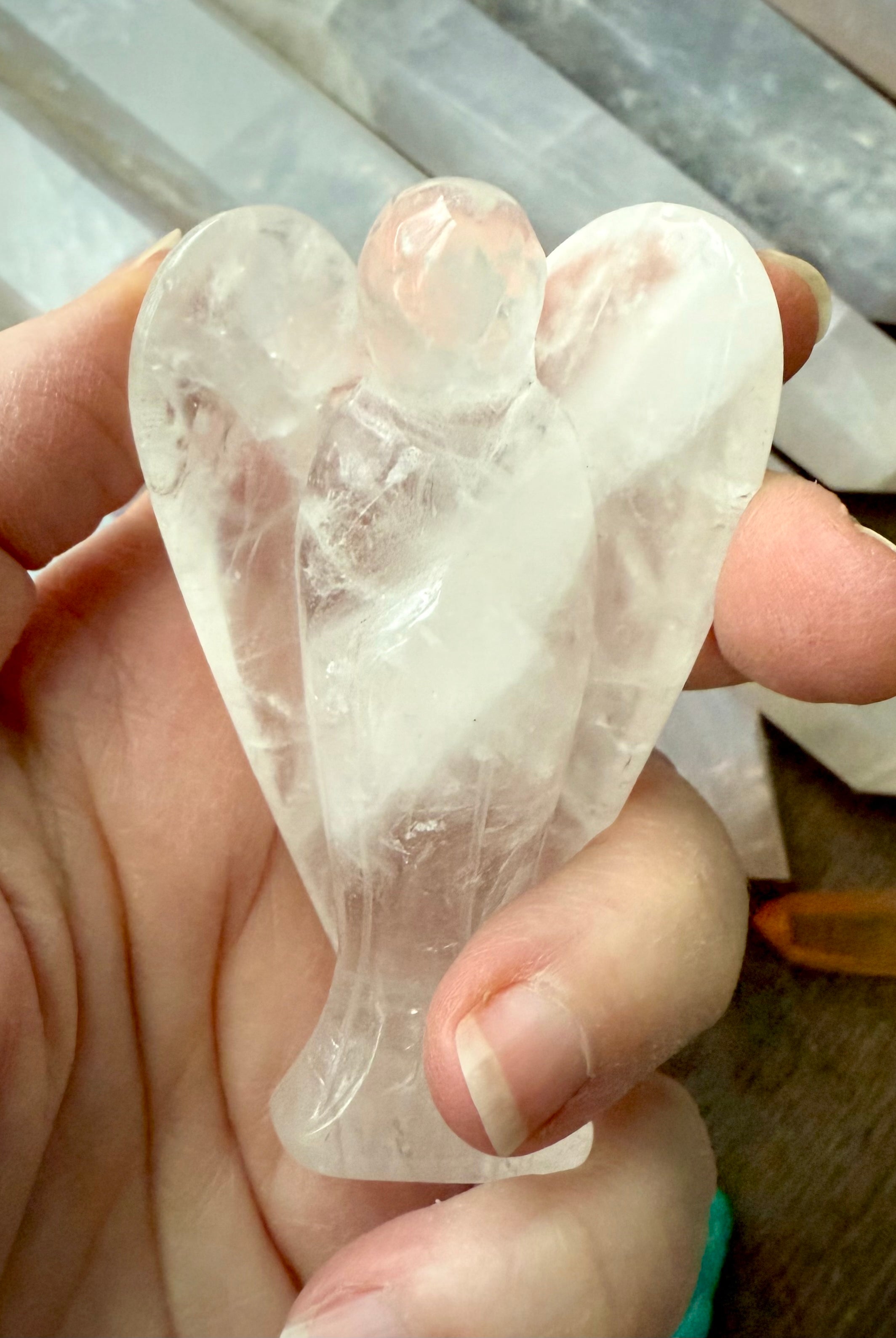 a one of a kind guardian angel hand-carved from natural clear quartz crystal to hold in meditation