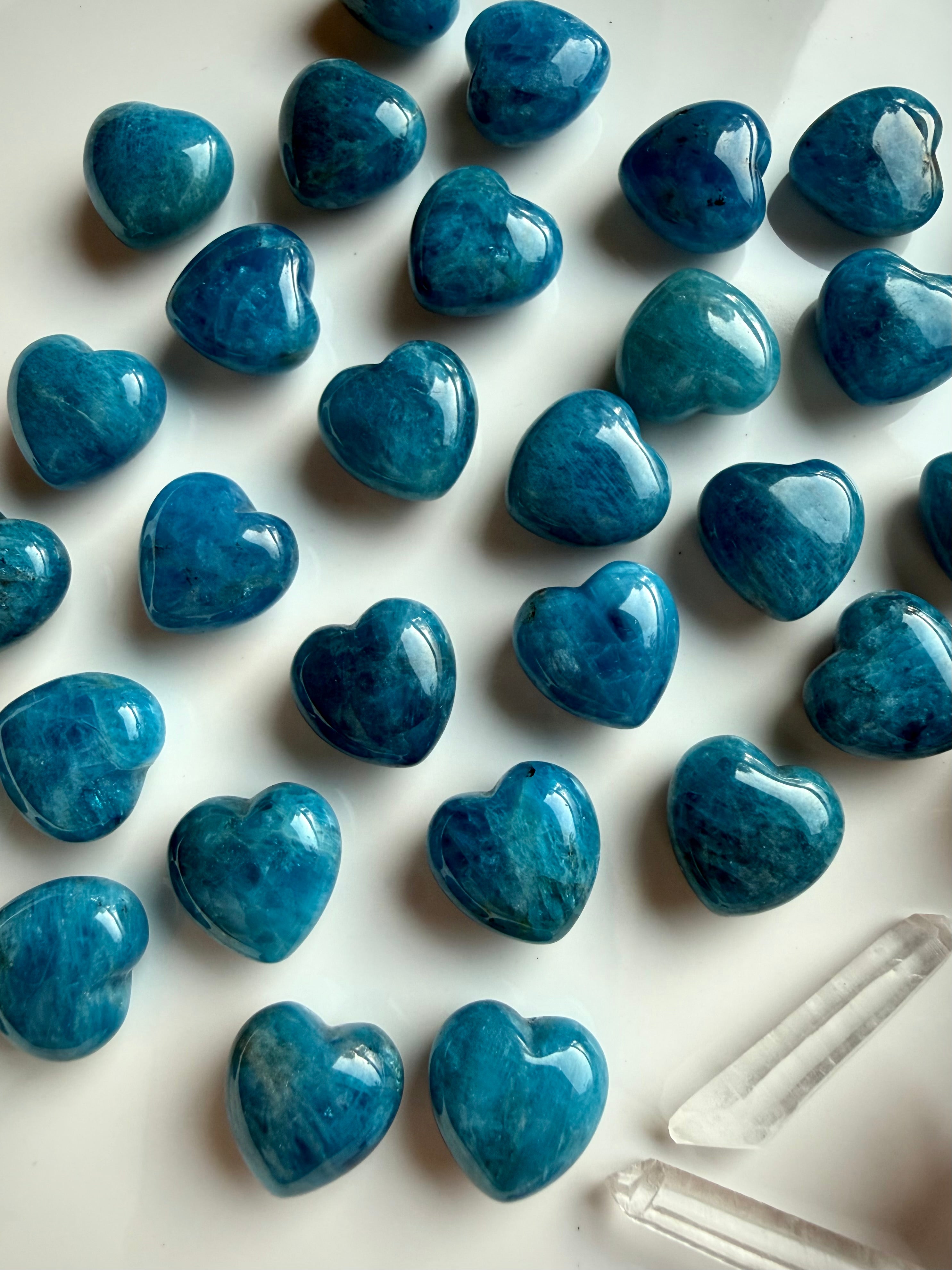 Close-up of polished Blue Apatite heart carving highlighting vibrant blue tones, subtle internal texture, and smooth rounded heart shape