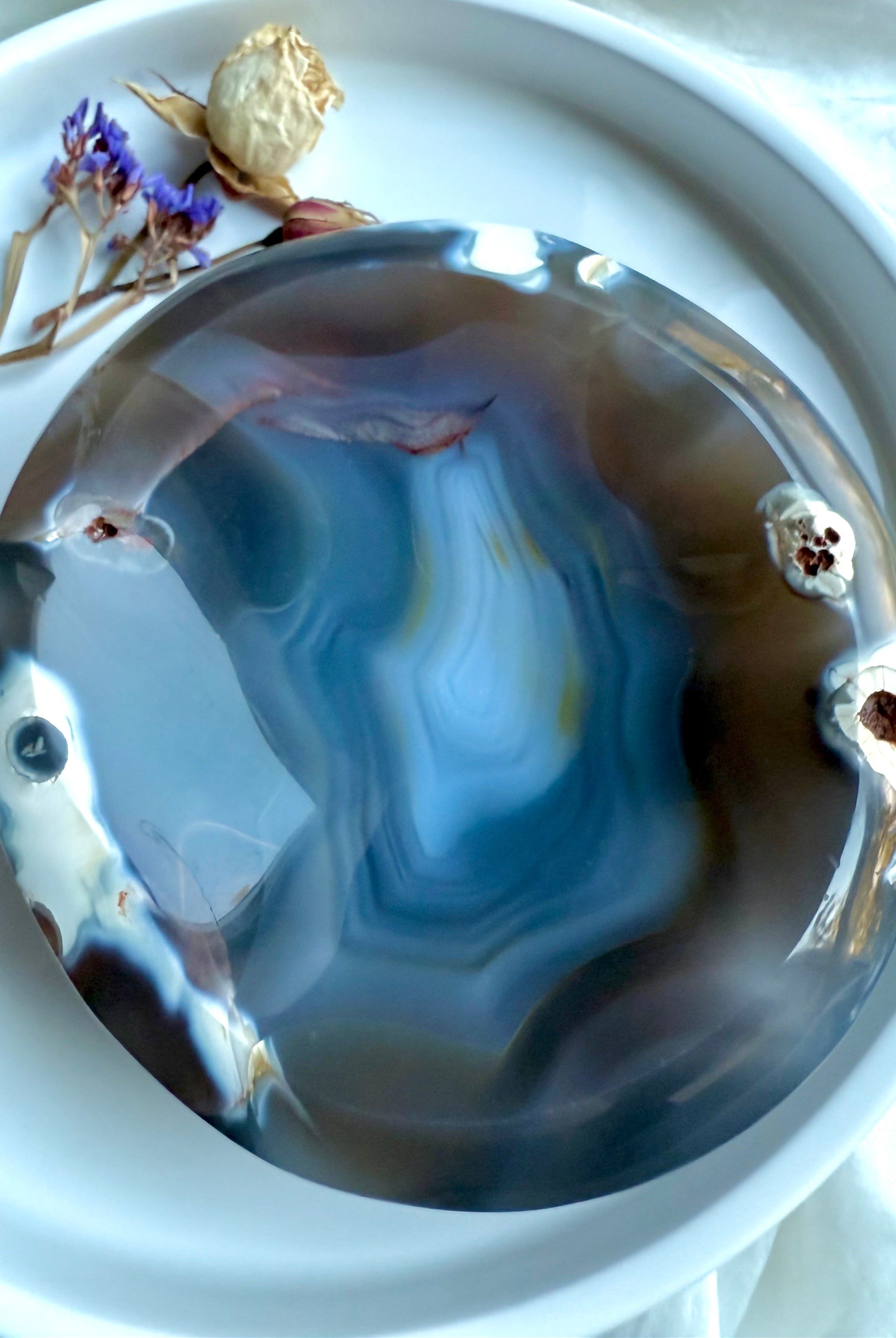 Close-up of Orca Agate offering bowl highlighting ocean-like blue layers and natural druzy details