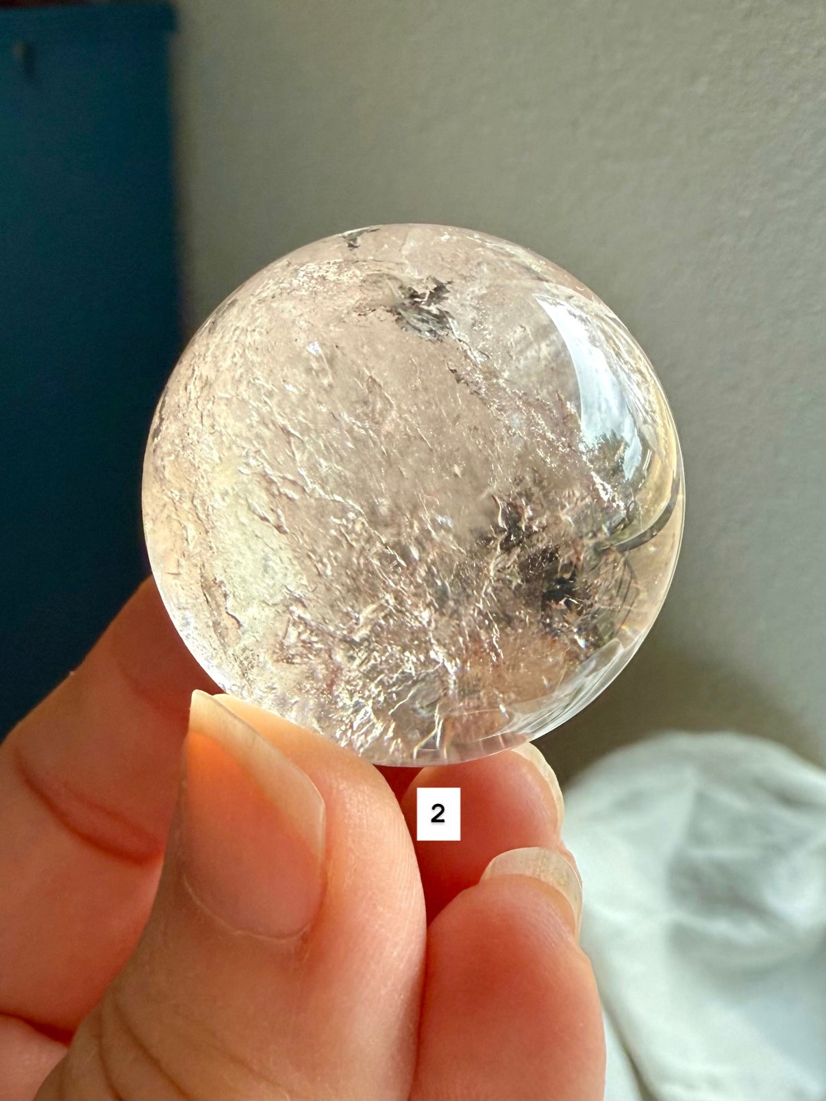 close up of a garden quartz sphere – mineral-filled lodolite for spiritual focus and grounding