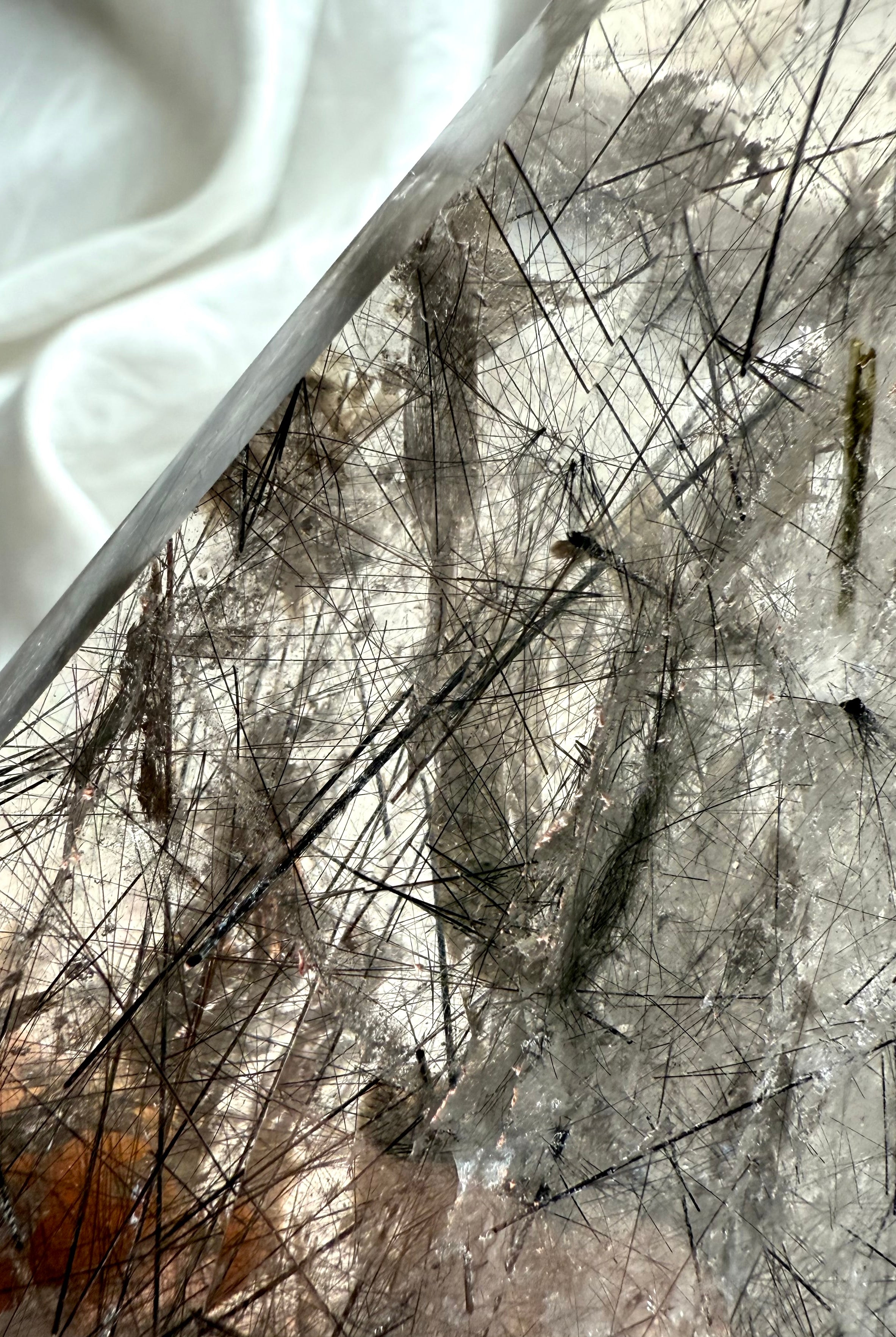 Close up of Tourmalinated Quartz showing dramatic Black Tourmaline blades suspended inside the crystal