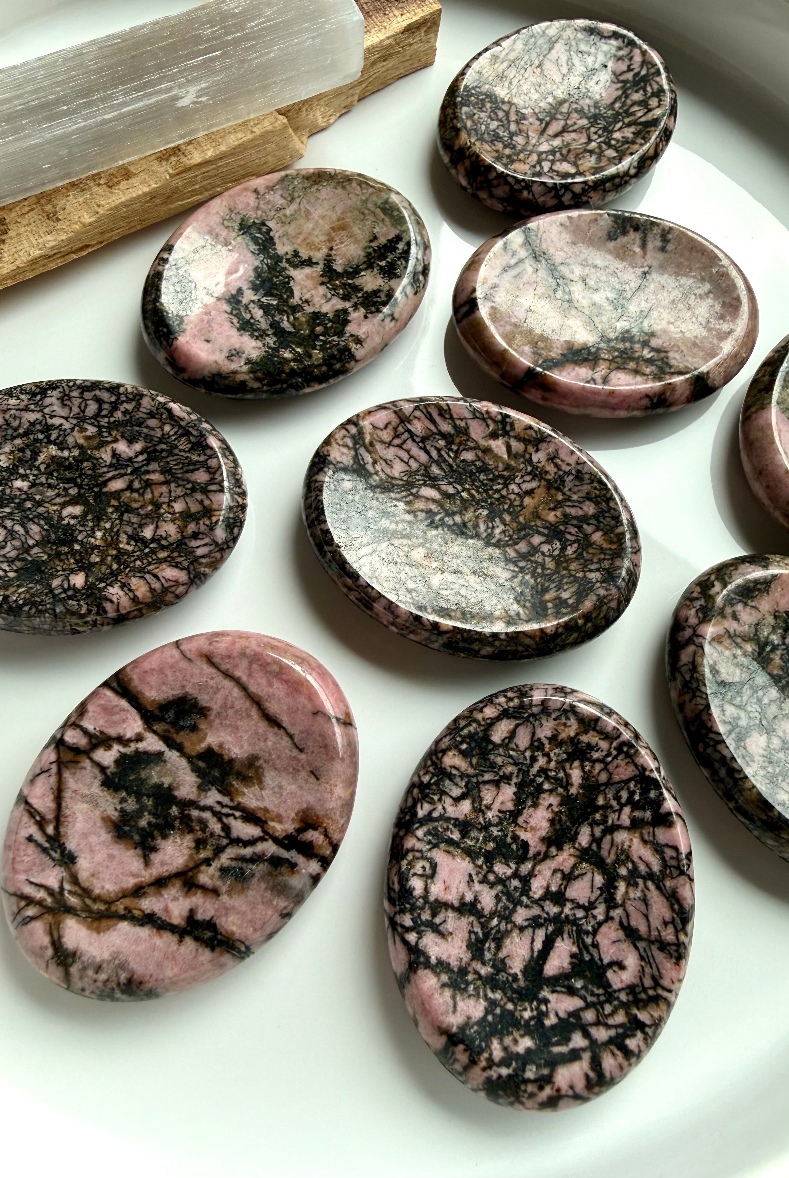Natural Rhodonite worry stones with varied spiderweb and dendritic veining