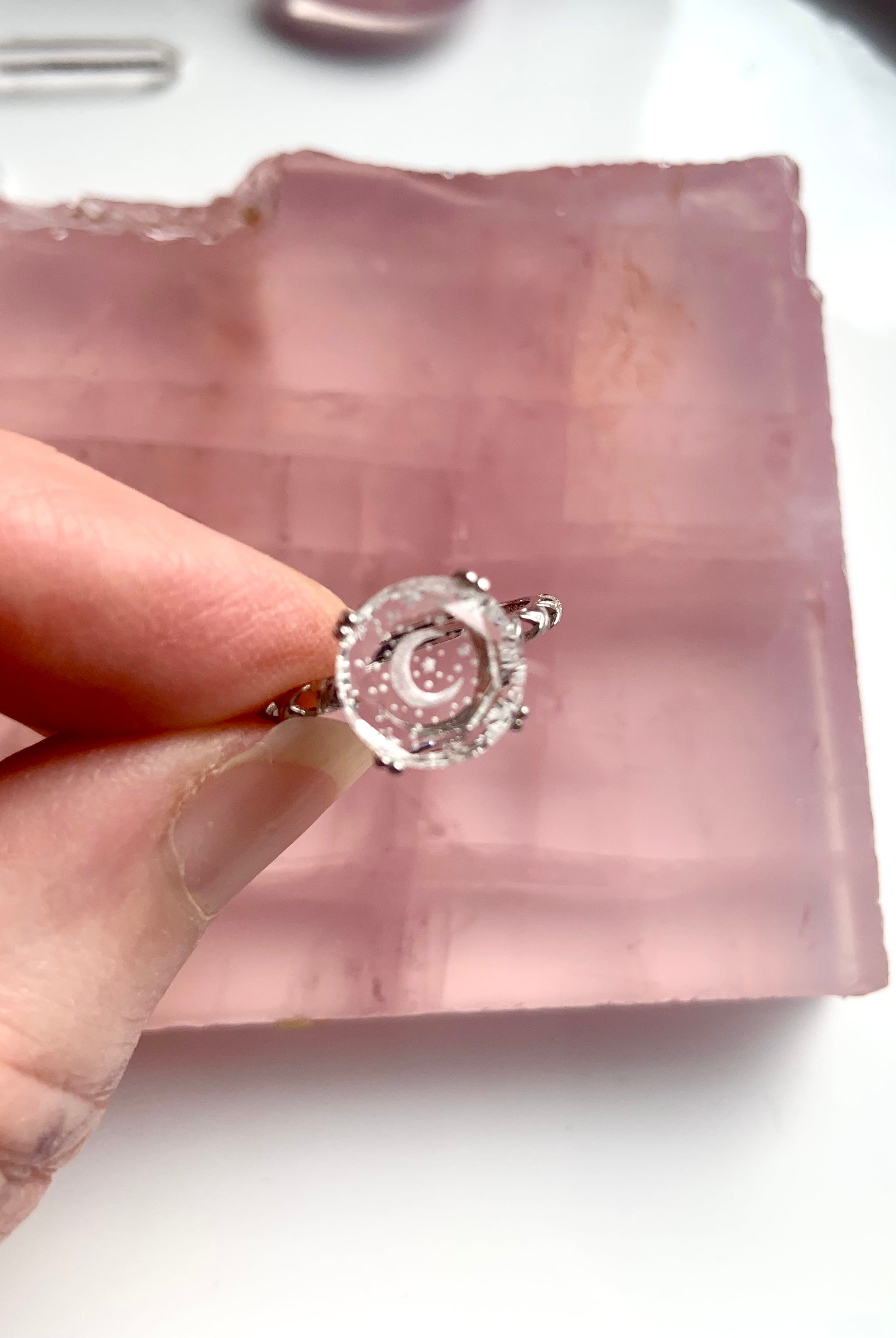 top view of etched crescent moon and stars on quartz gemstone ring