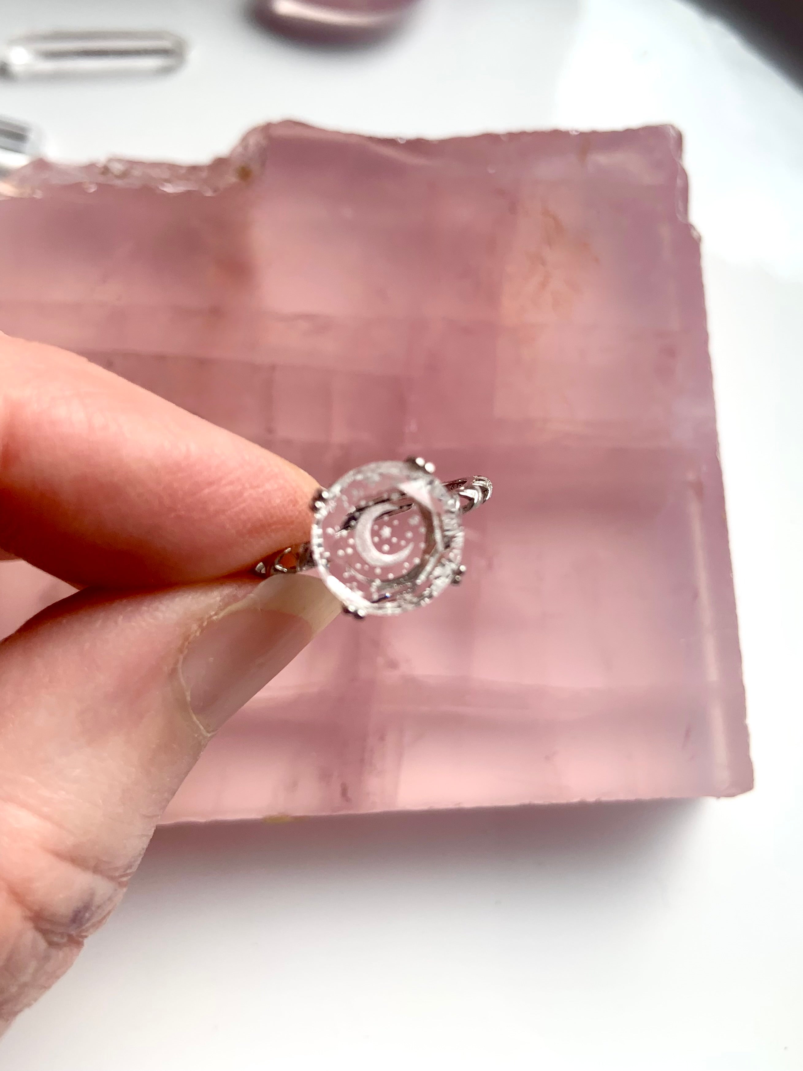 top view of etched crescent moon and stars on quartz gemstone ring
