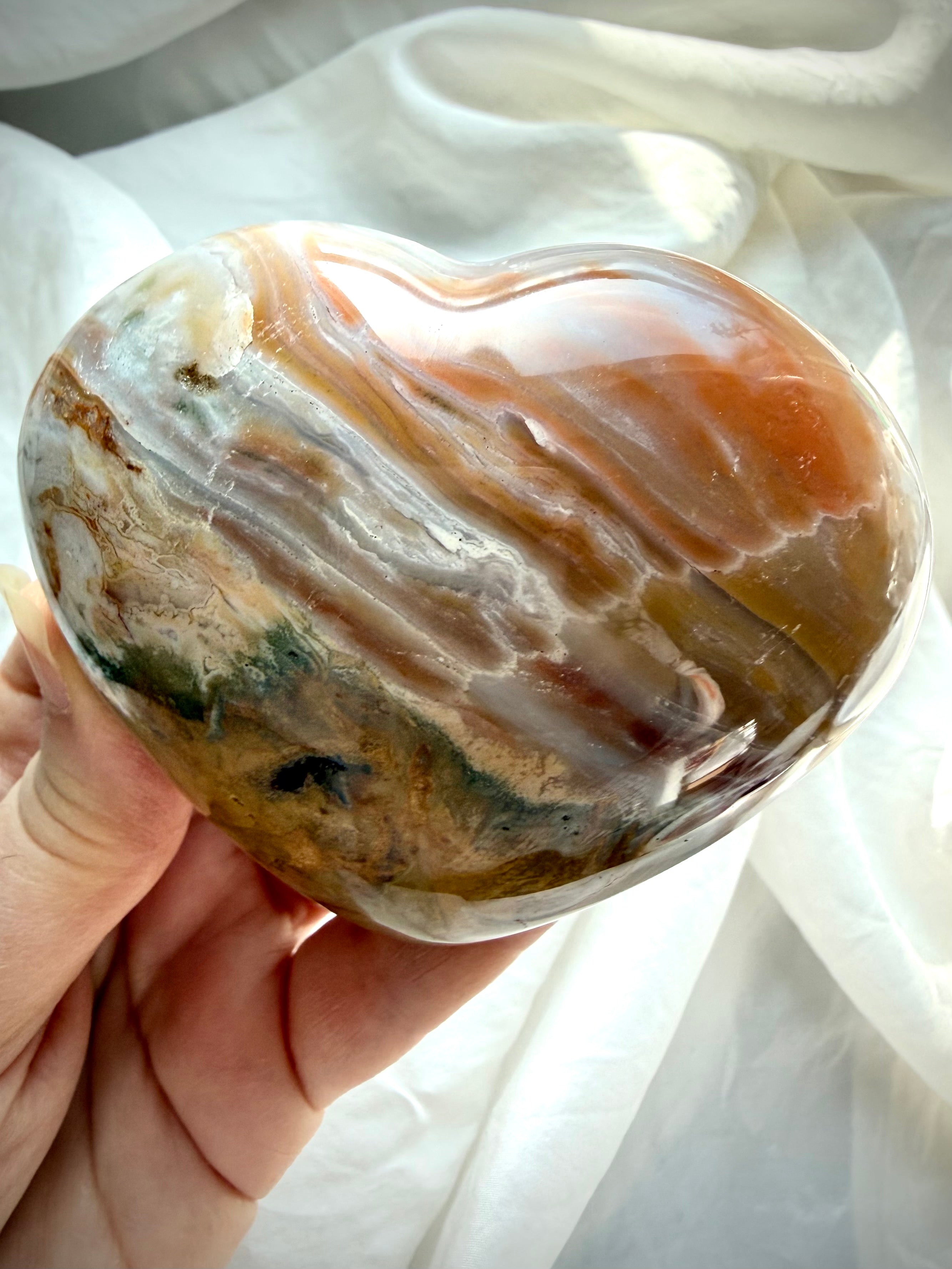 Detailed view of non-orbicular Ocean Jasper heart with natural chalcedony layers and mossy green mineral formations