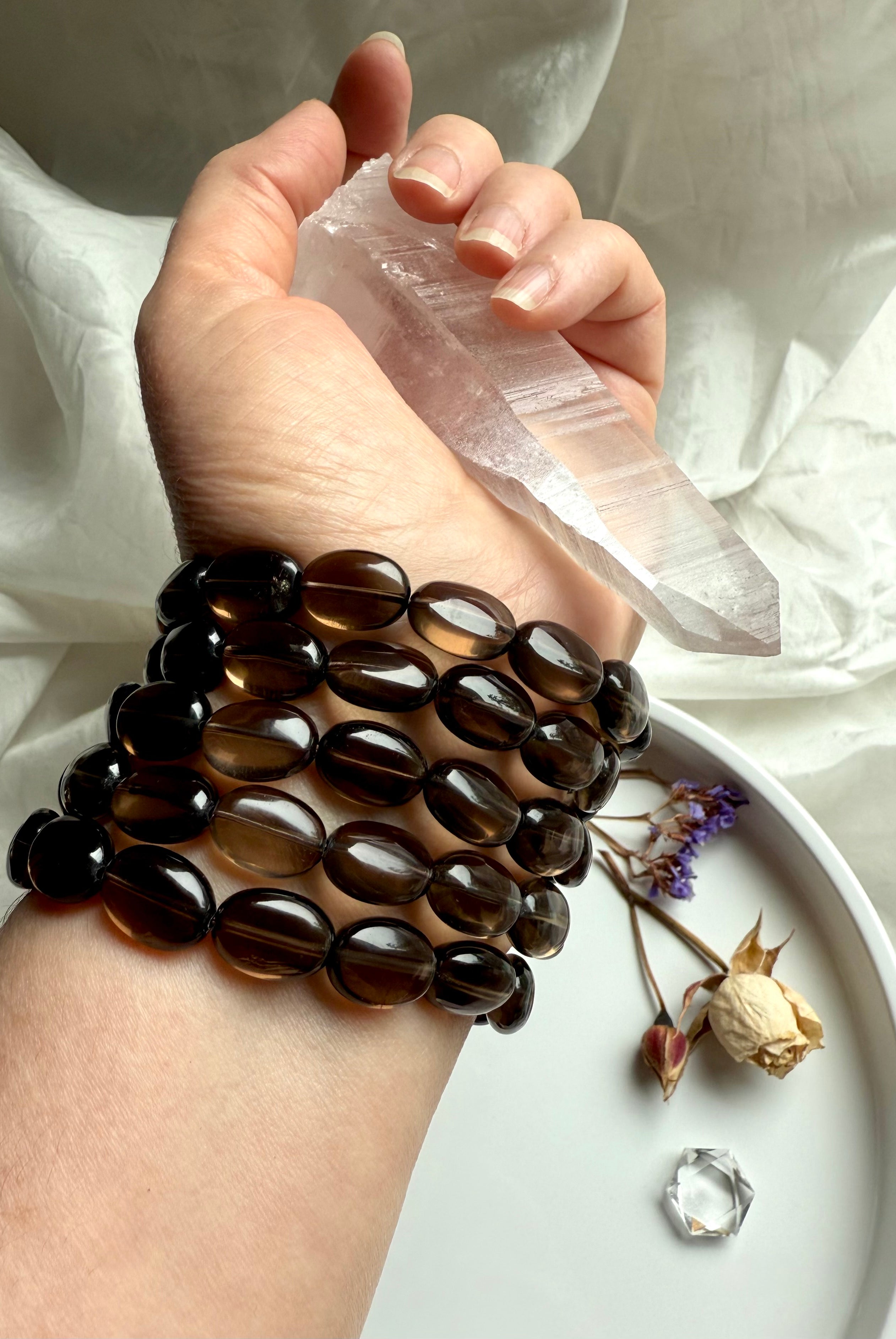 Smoky Quartz bracelets worn with Lemurian Quartz point – crystal jewelry for grounding and clarity