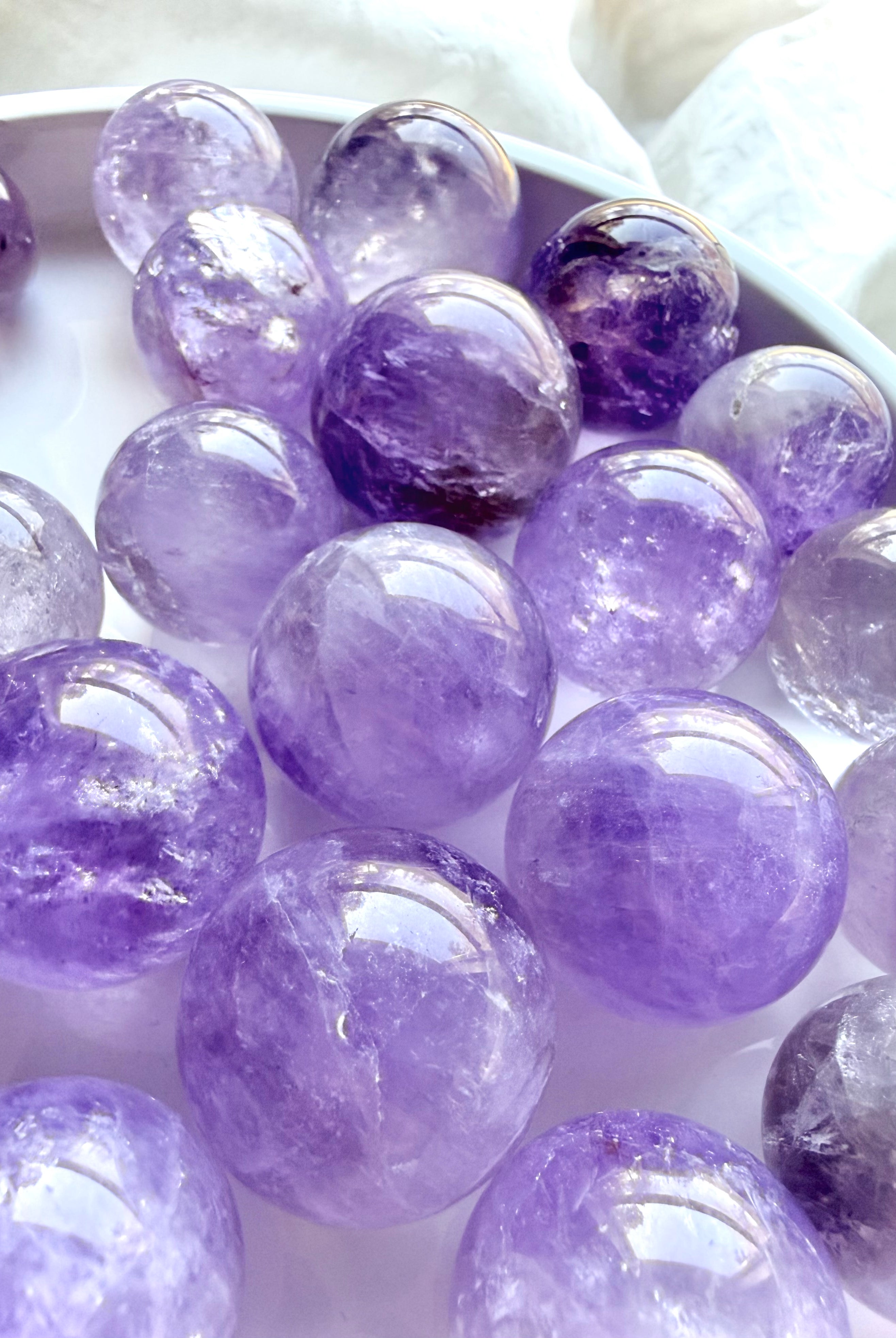 mini smoky amethyst spheres group showing natural variation in color and clarity