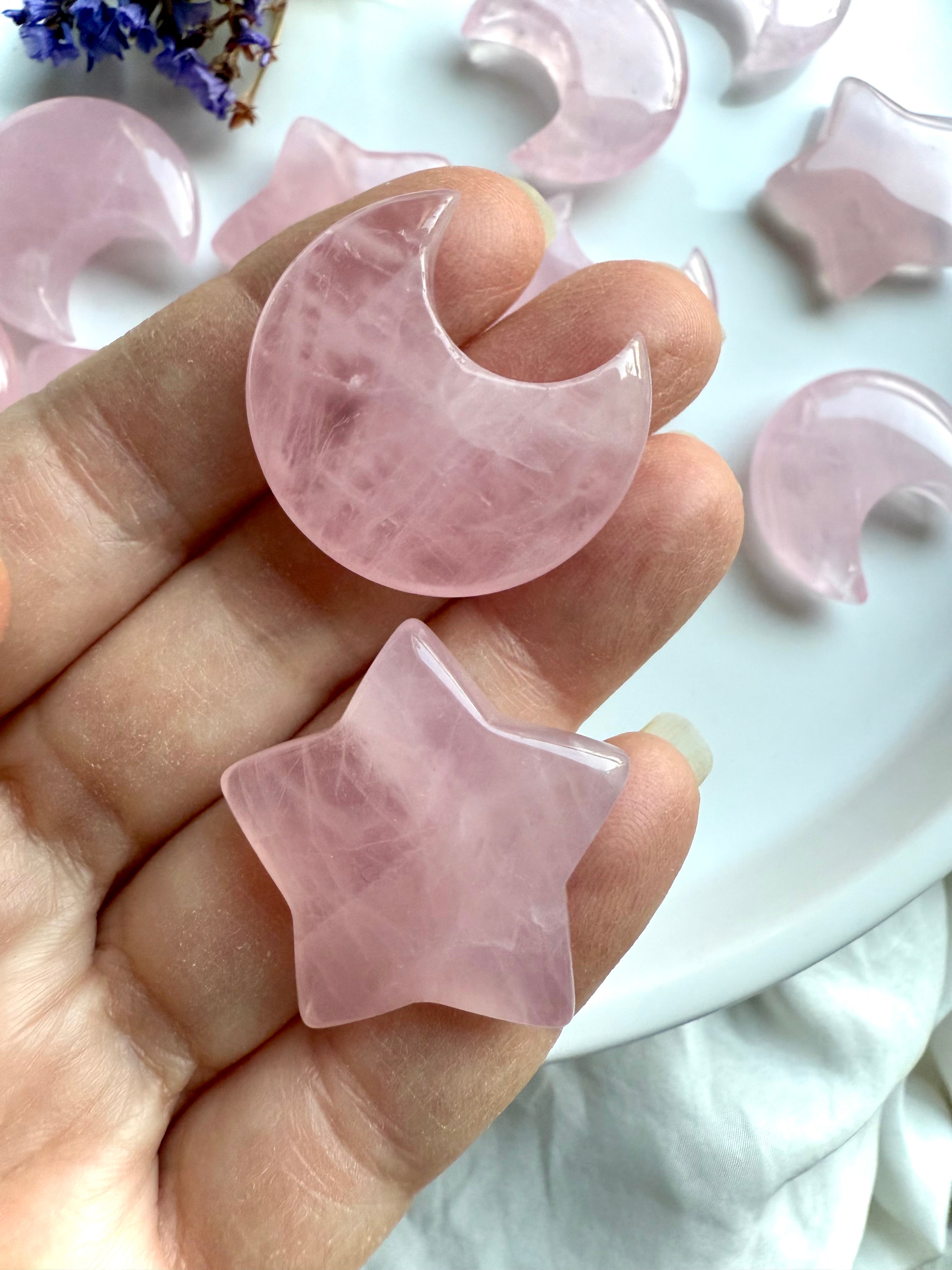 Close-up of Rose quartz moon and star crystals shown in hand for scale. Heart Chakra stones perfect for meditation or gifting.