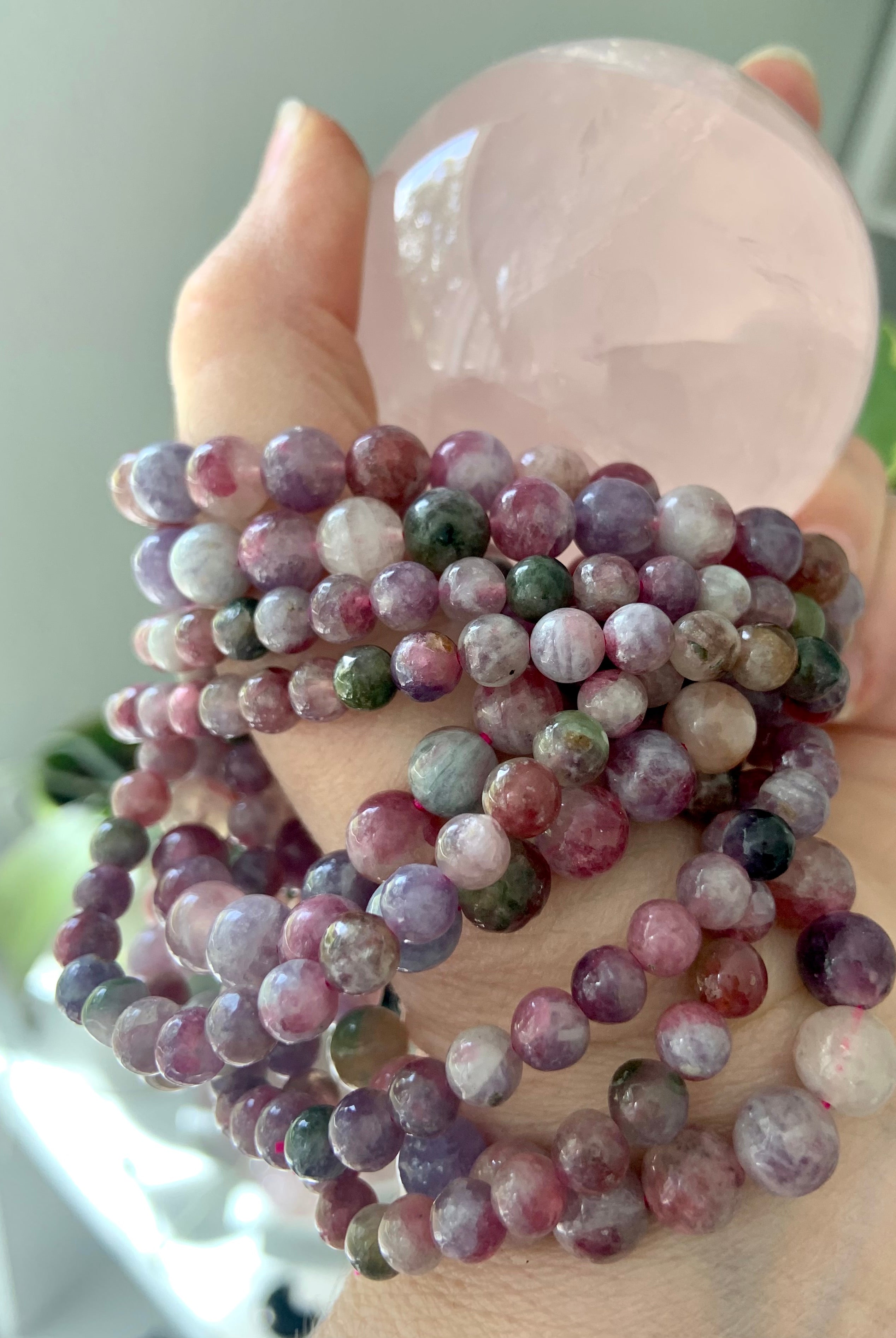 Heart chakra crystal stack with Watermelon Tourmaline & Lepidolite bracelets and rose quartz sphere — calming stones for emotional healing + self-love