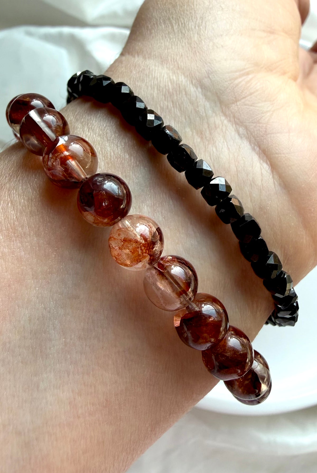 Fire Quartz bracelet stacked with a Faceted Black Spinel bracelet for crystal jewelry styling, Root Chakra crystals for grounding and vitality