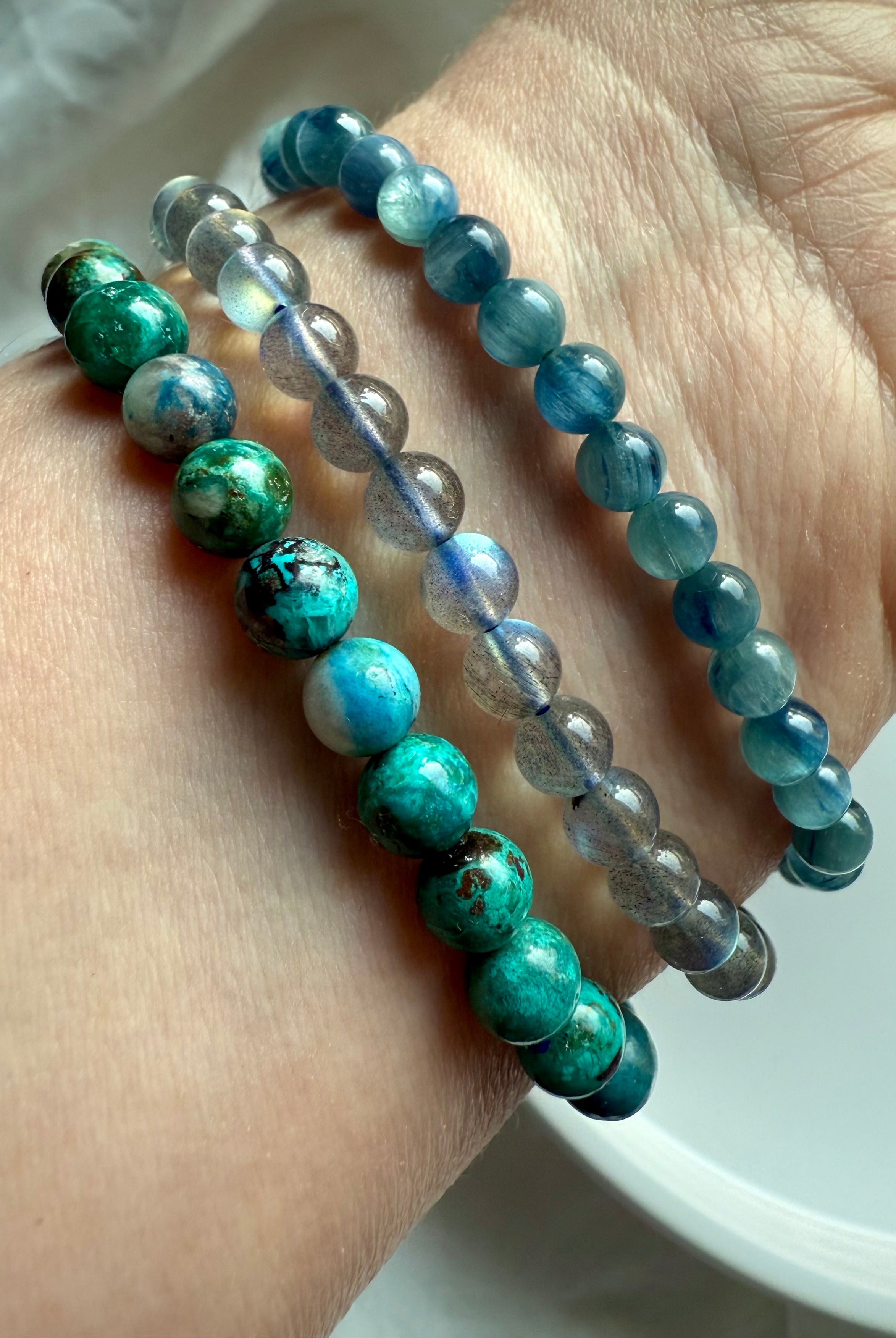 Crystal bracelet stack featuring Chrysocolla Shattuckite, Teal Kyanite, and Labradorite for spiritual clarity, expression, and energy balance