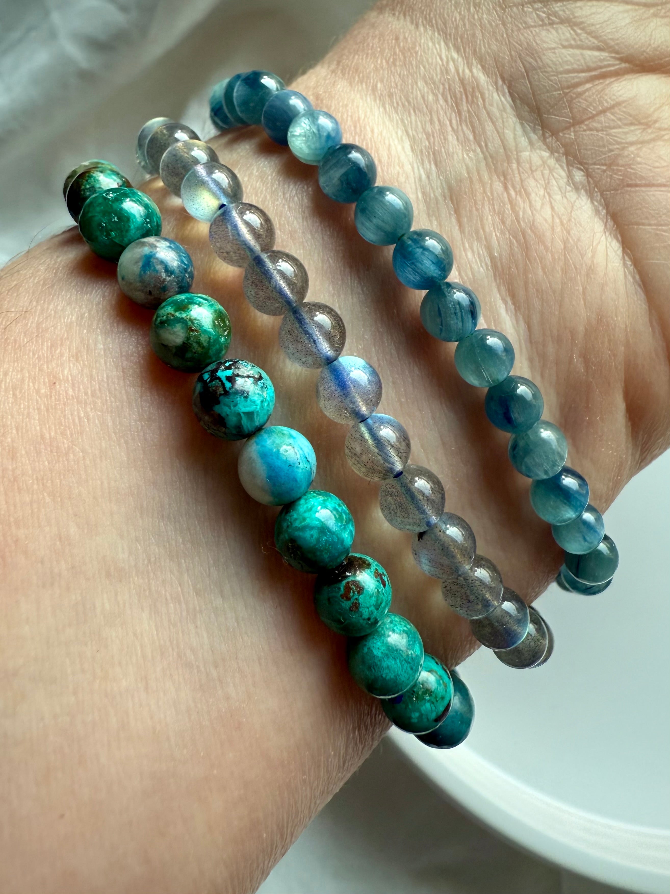 Crystal bracelet stack featuring Chrysocolla Shattuckite, Teal Kyanite, and Labradorite for spiritual clarity, expression, and energy balance