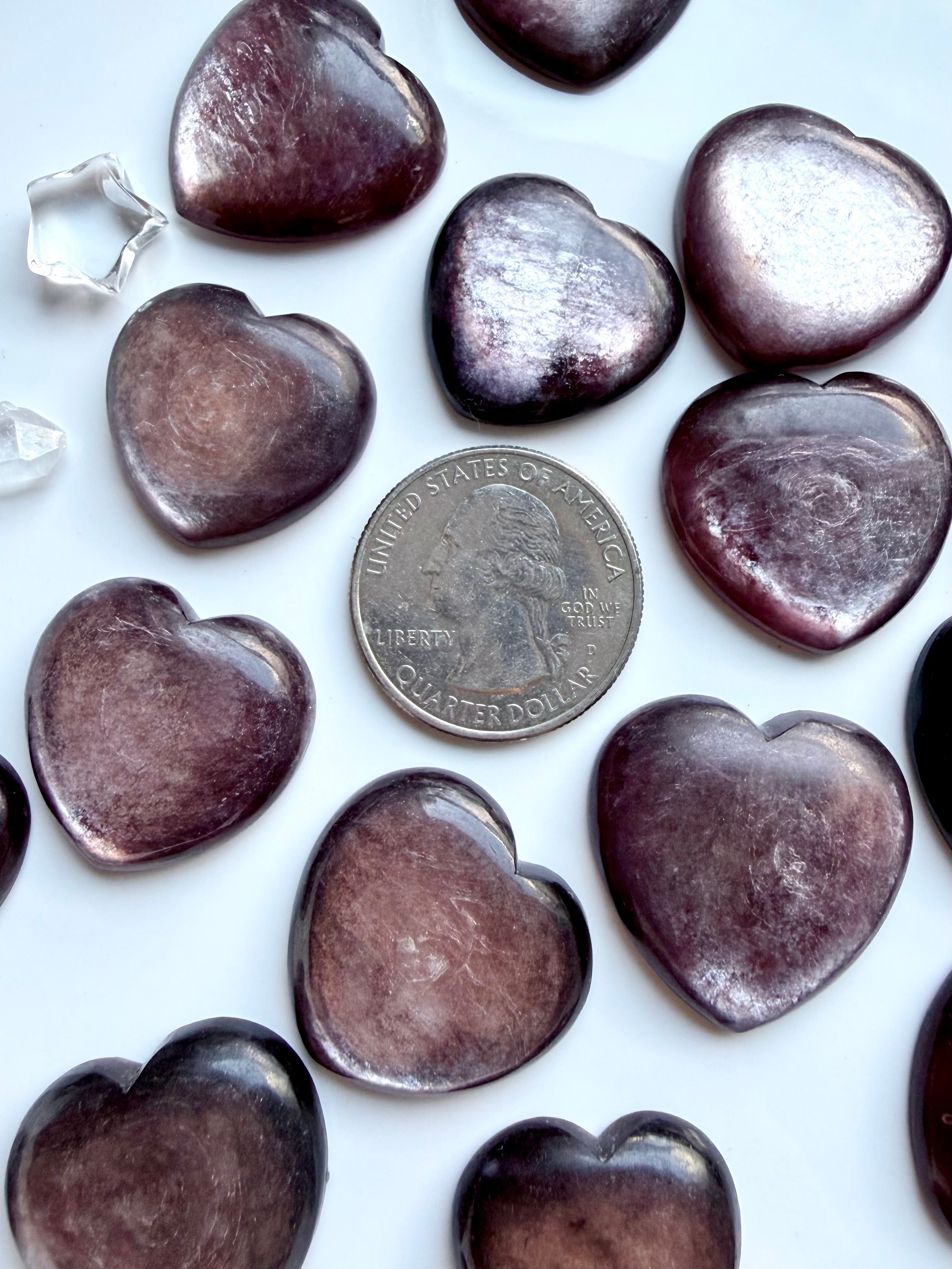 Gem lepidolite hearts shown with a US quarter for scale showing color, shimmer & natural patterning