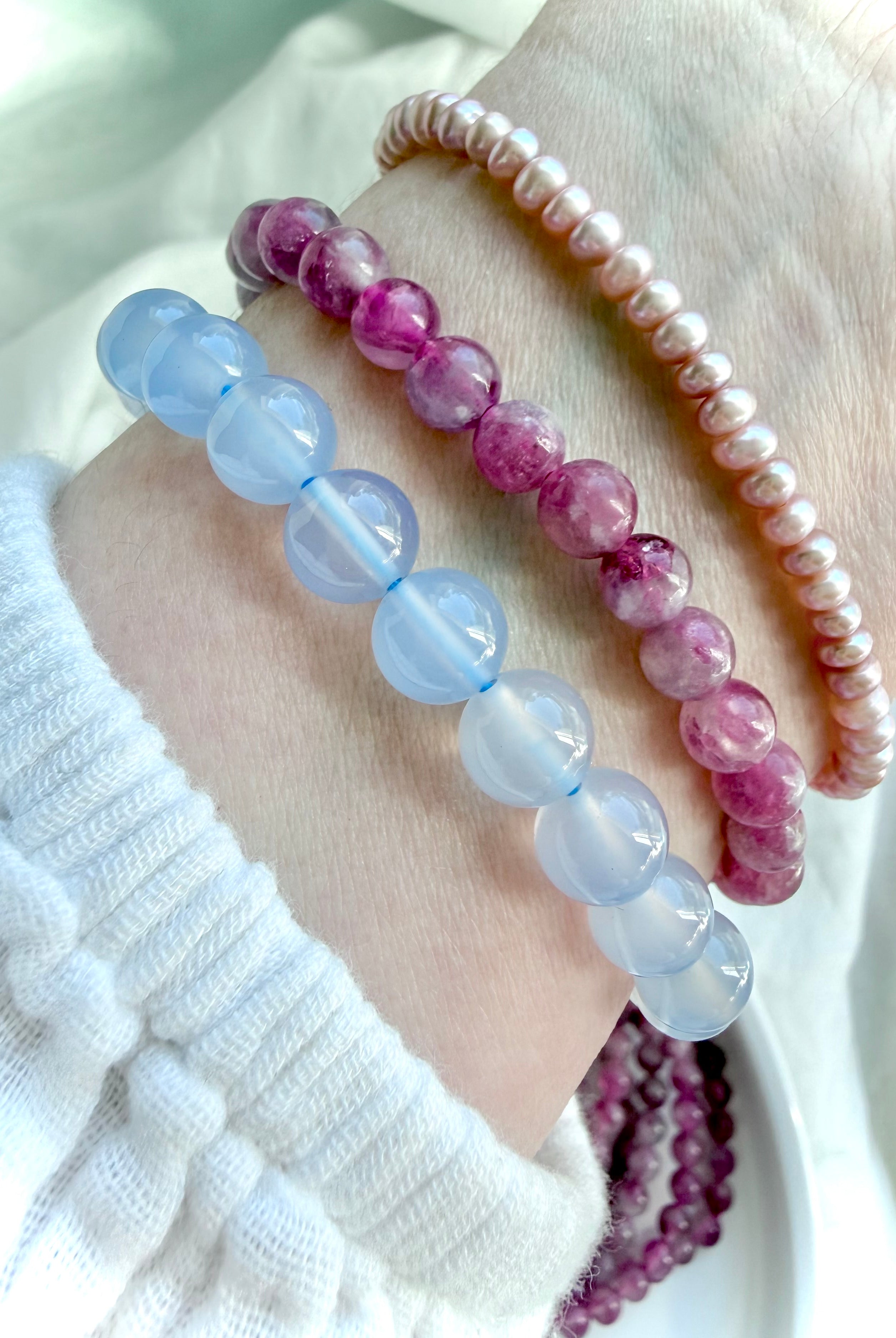 Pink Tourmaline bracelet stacked with Blue Chalcedony and Freshwater Pearl bracelets for elegant crystal jewelry layering inspiration
