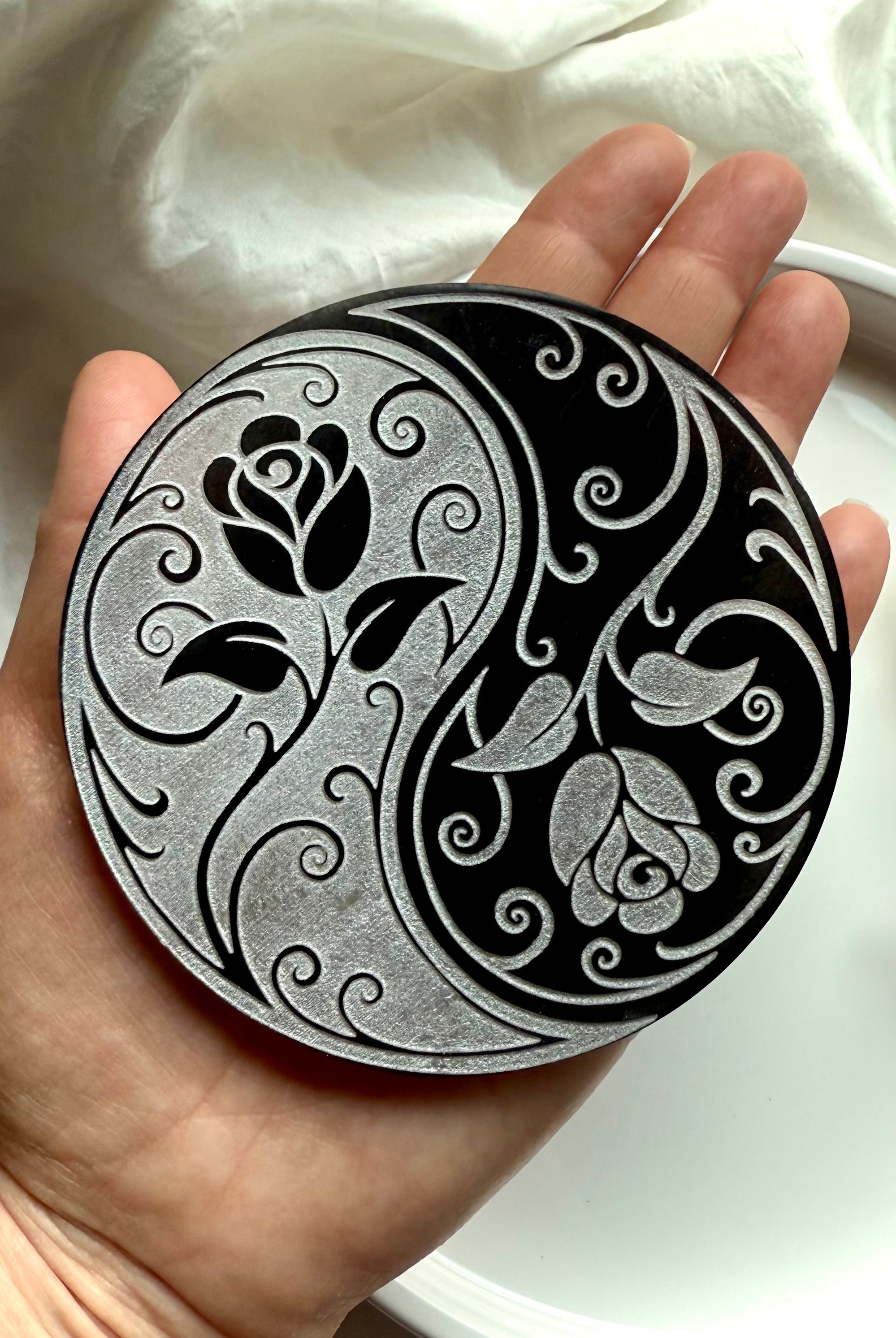 Selenite yin yang rose plate held in hand with dried flowers and crystals for altar or sacred space energy work