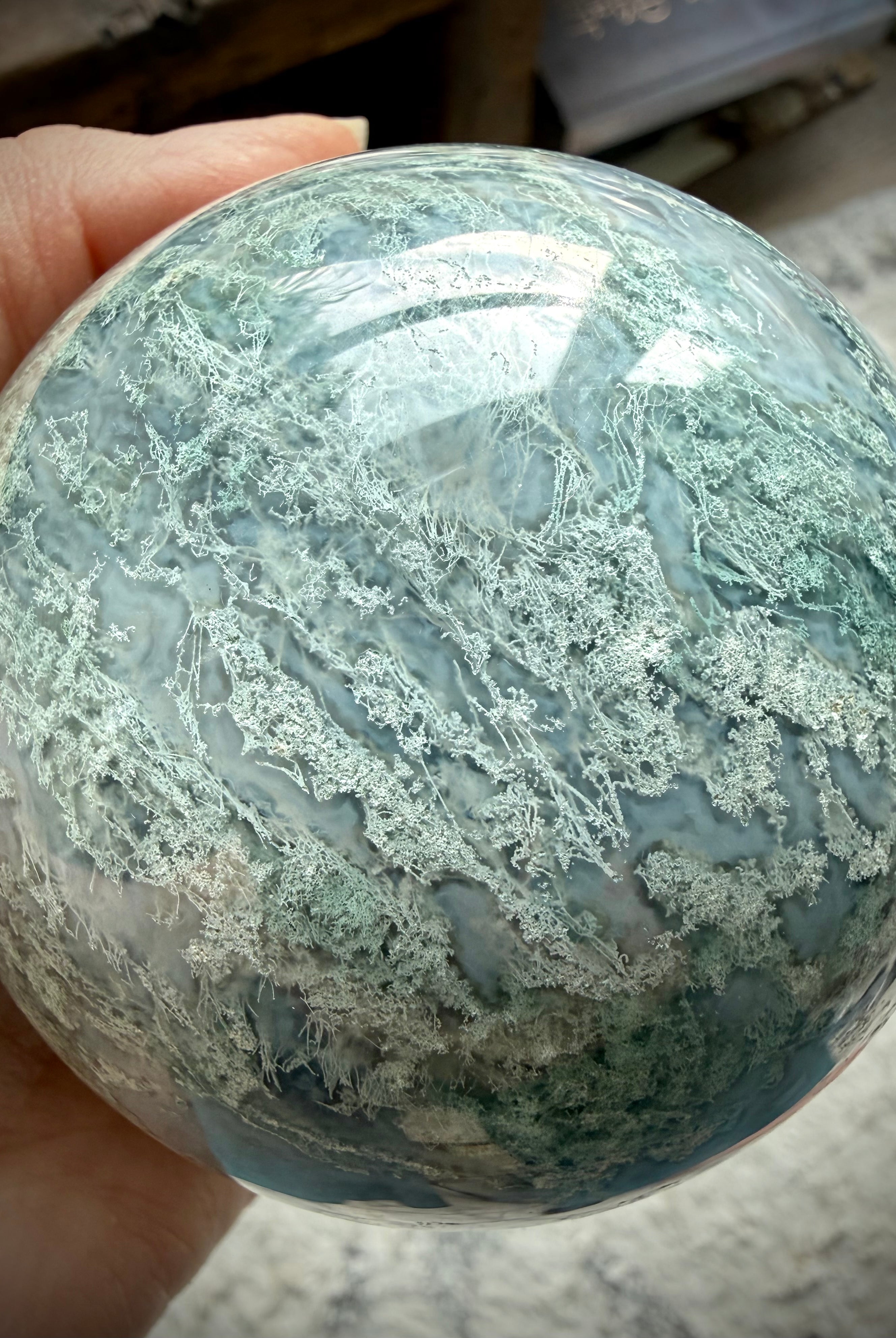 Rare Moss Agate crystal ball with natural druzy texture, organic patterns, and unique mineral details
