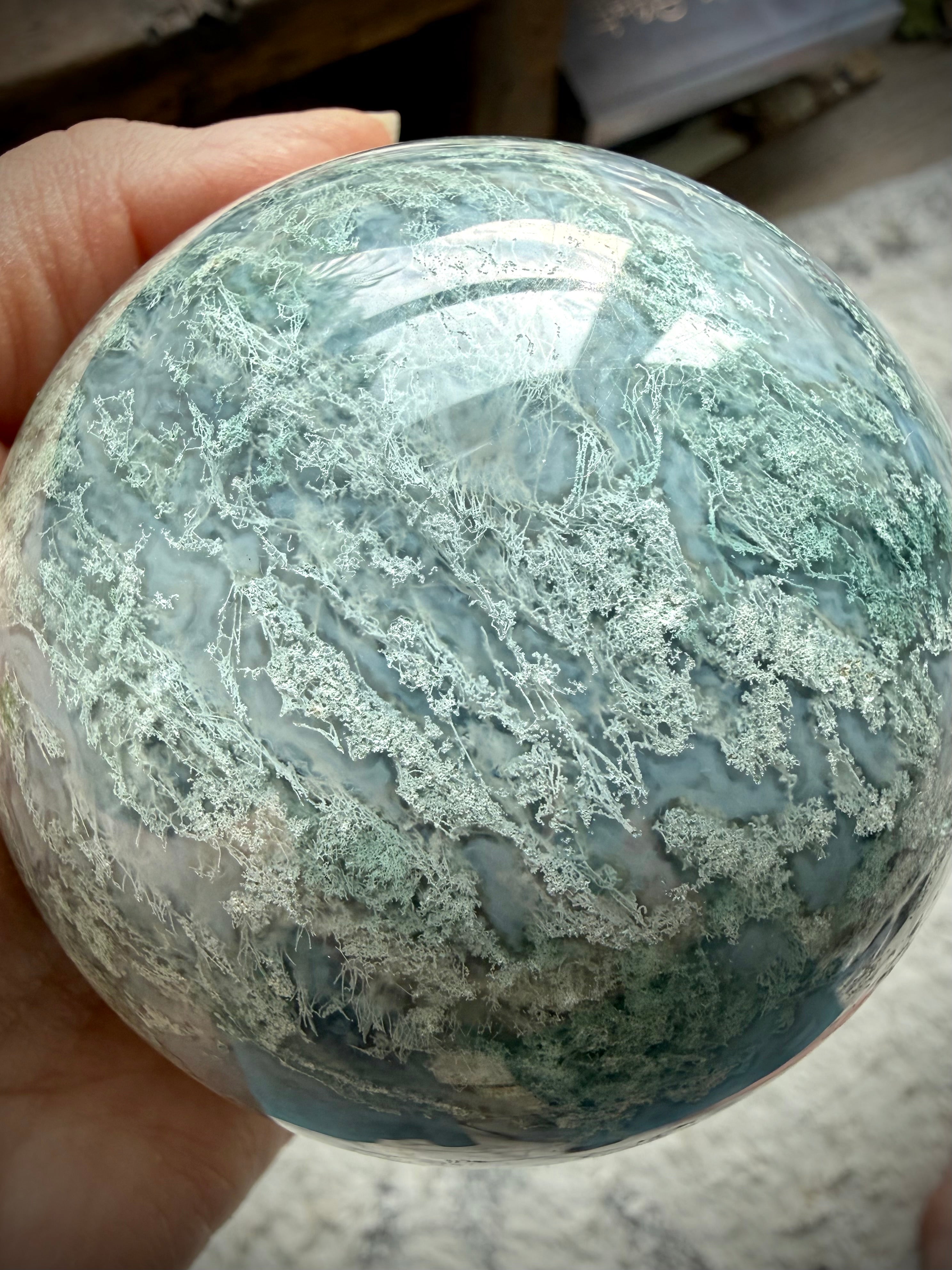 Rare Moss Agate crystal ball with natural druzy texture, organic patterns, and unique mineral details