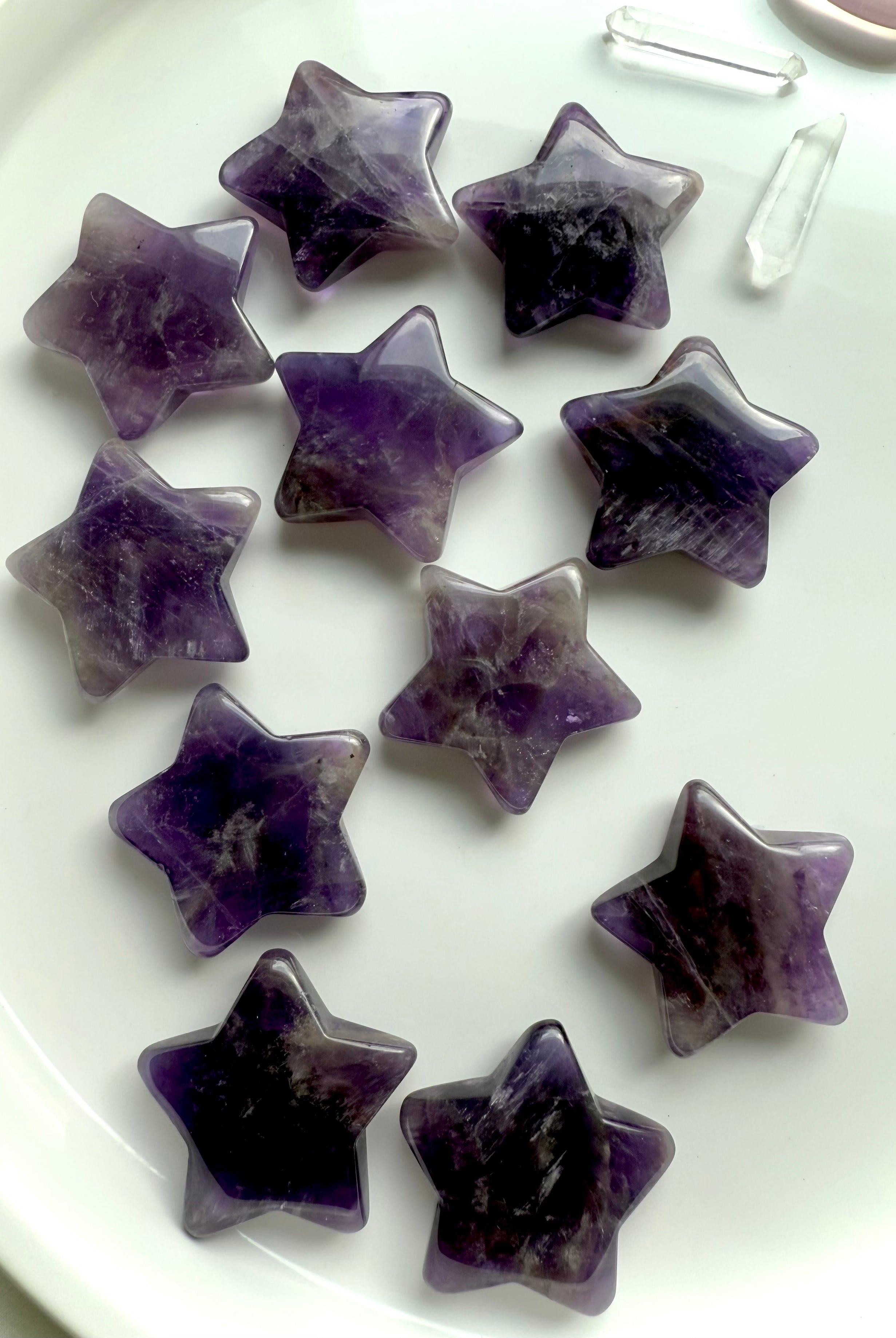 An array of dream amethyst stars on a white background