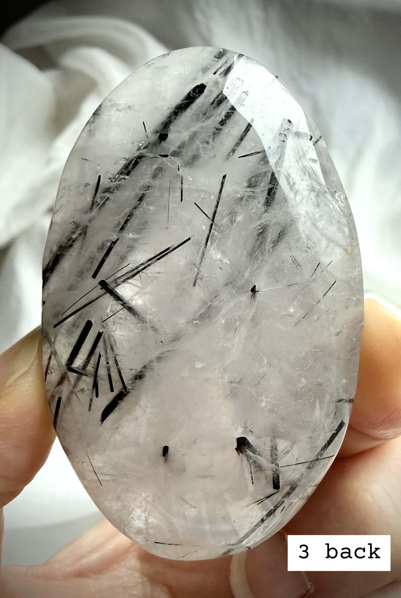 Black Tourmaline in Quartz palm stone 3 back view with black tourmaline needle inclusions