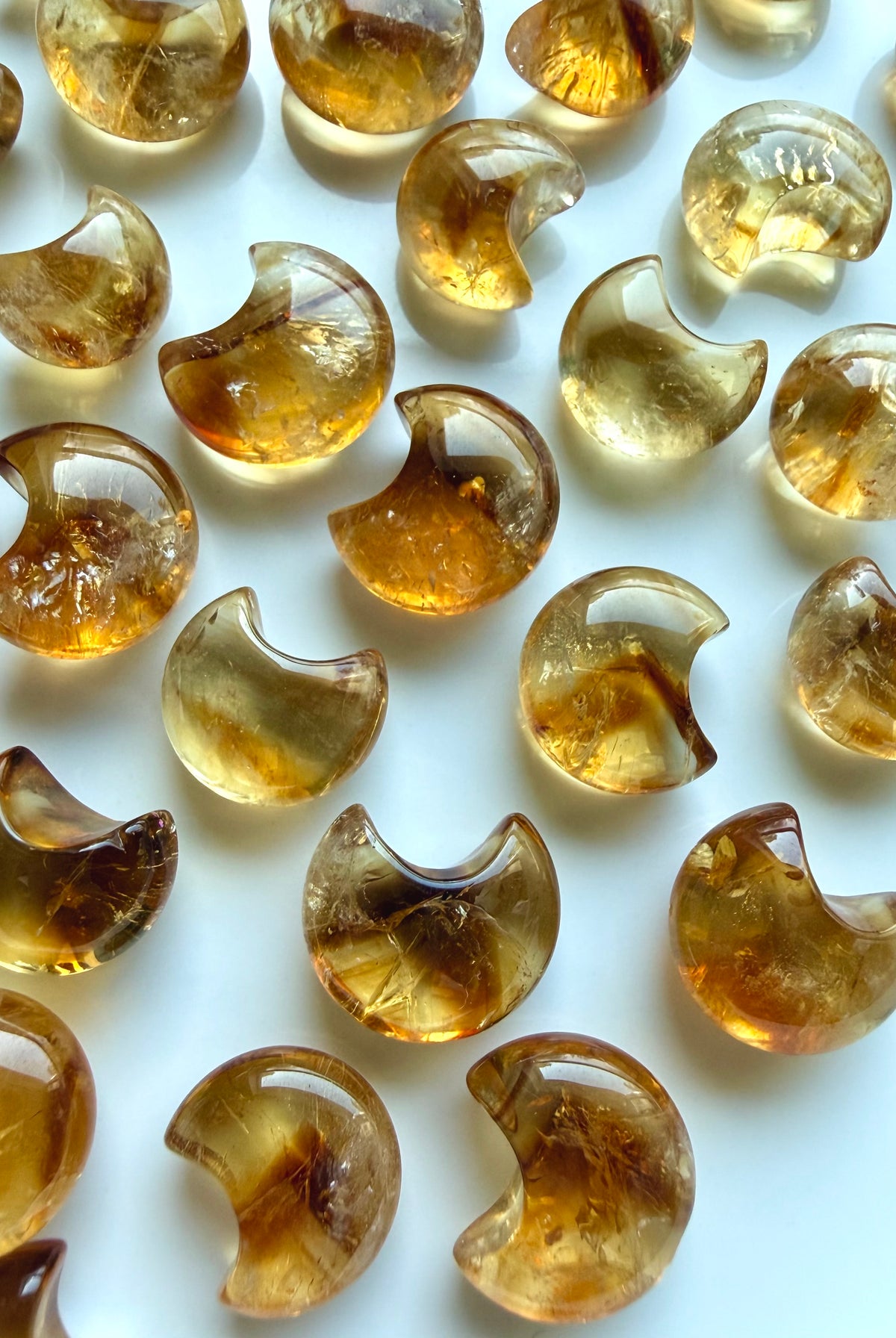 Polished Mini Citrine moons with luminous amber color, beautiful clarity and occasional phantom-like lines