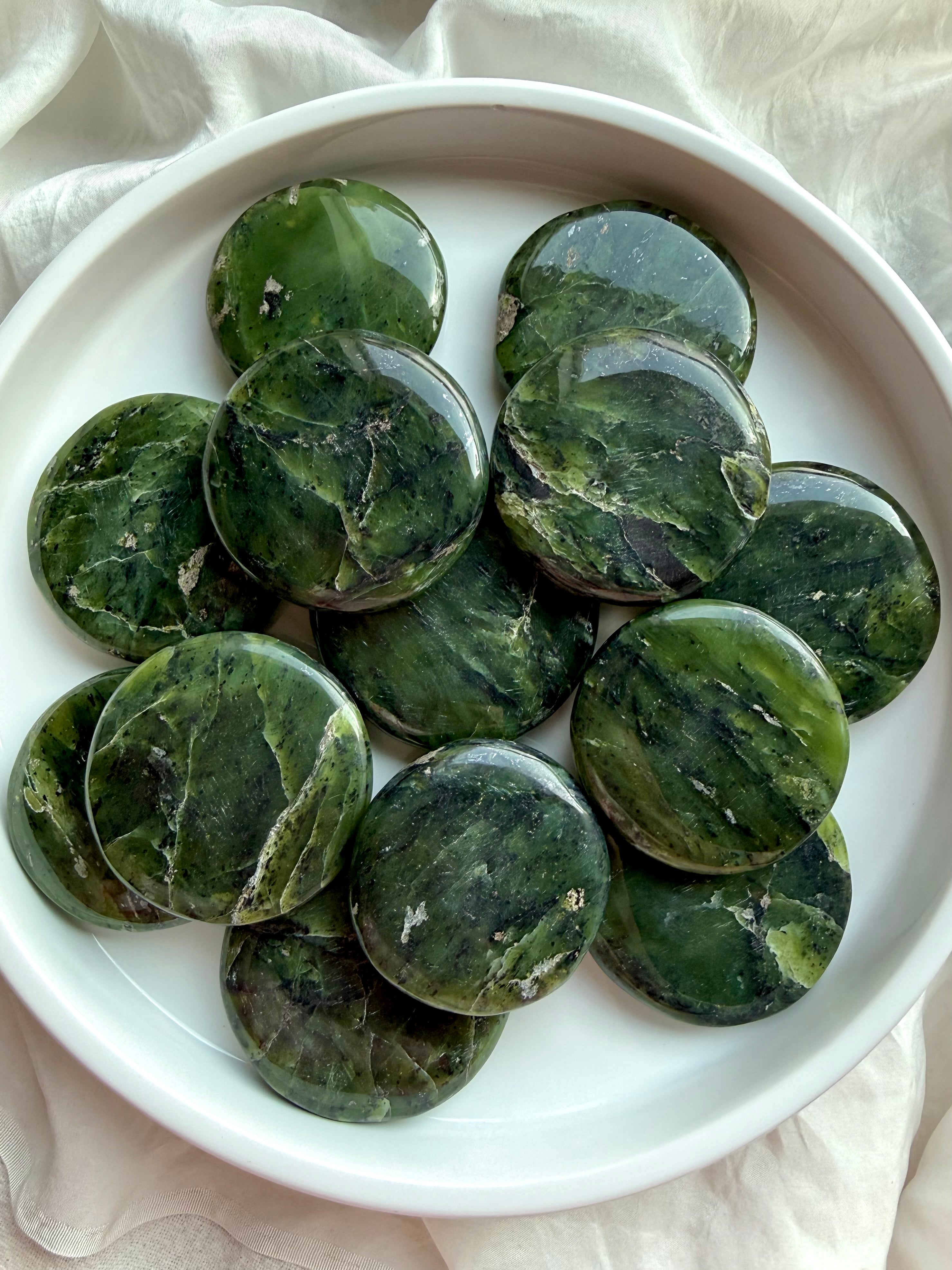 Full tray of nephrite jade palm stones with rich green marbling, polished heart chakra crystals for grounding, meditation, and emotional balance