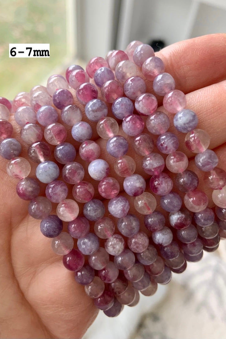 Unicorn Stone bracelets with 6–7mm beads — pink and purple tourmaline crystal jewelry shown close up for size, quality, and color reference.