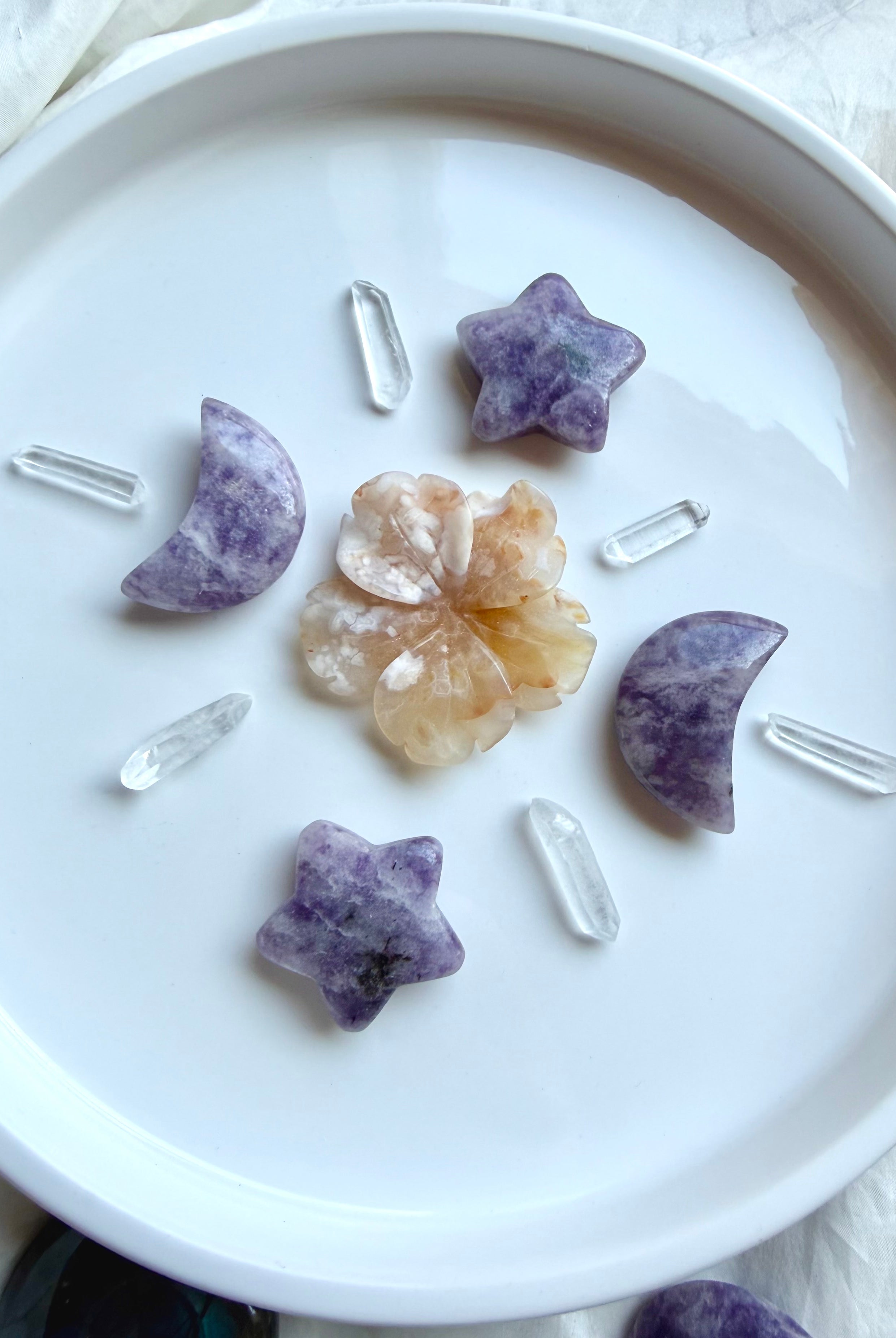 Lepidolite moon and star crystals with Flower Agate flower and Clear Quartz points arranged in a celestial crystal grid