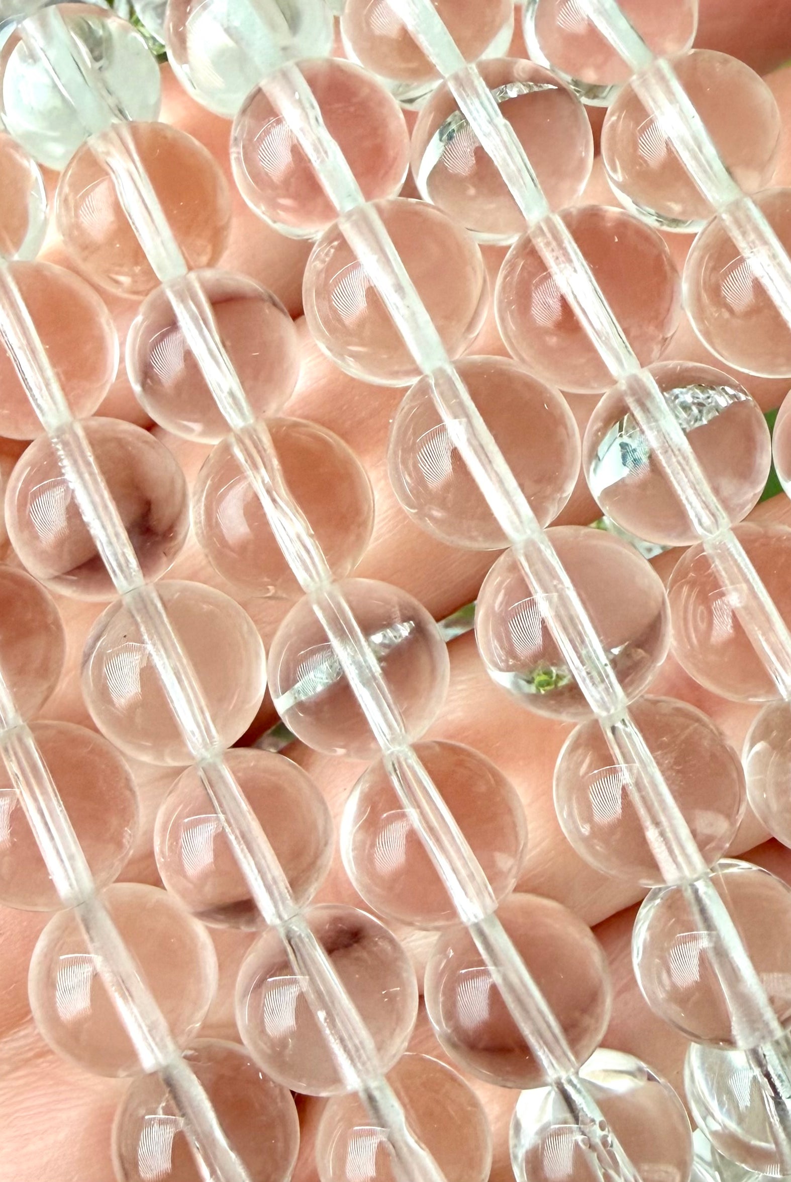 Close-up of Clear Quartz bracelet showing transparent polished crystal beads and natural clarity