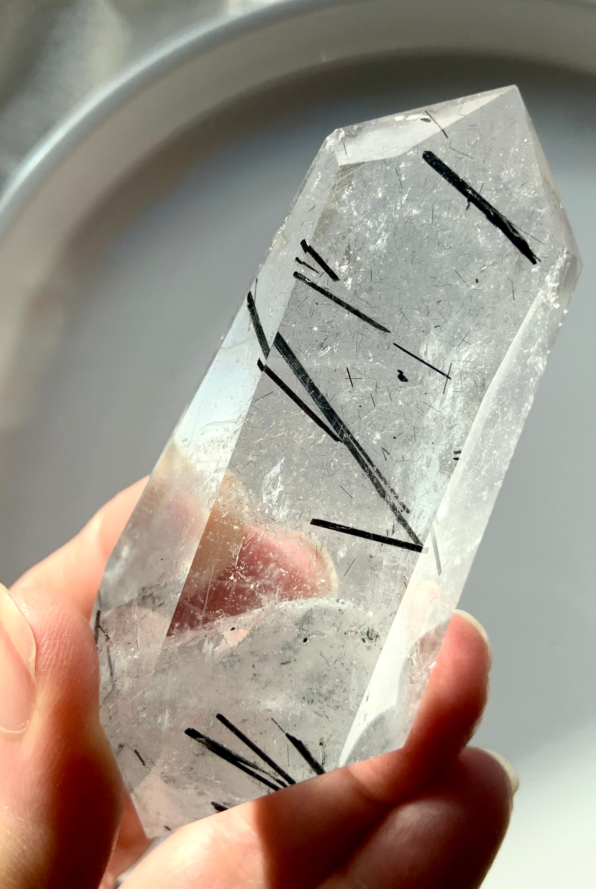Double Terminated Black Tourmaline in Quartz Point shown in my hand with a white plate in the background. High Quality Tourmalated Quartz makes a great Crystal Collector Gift