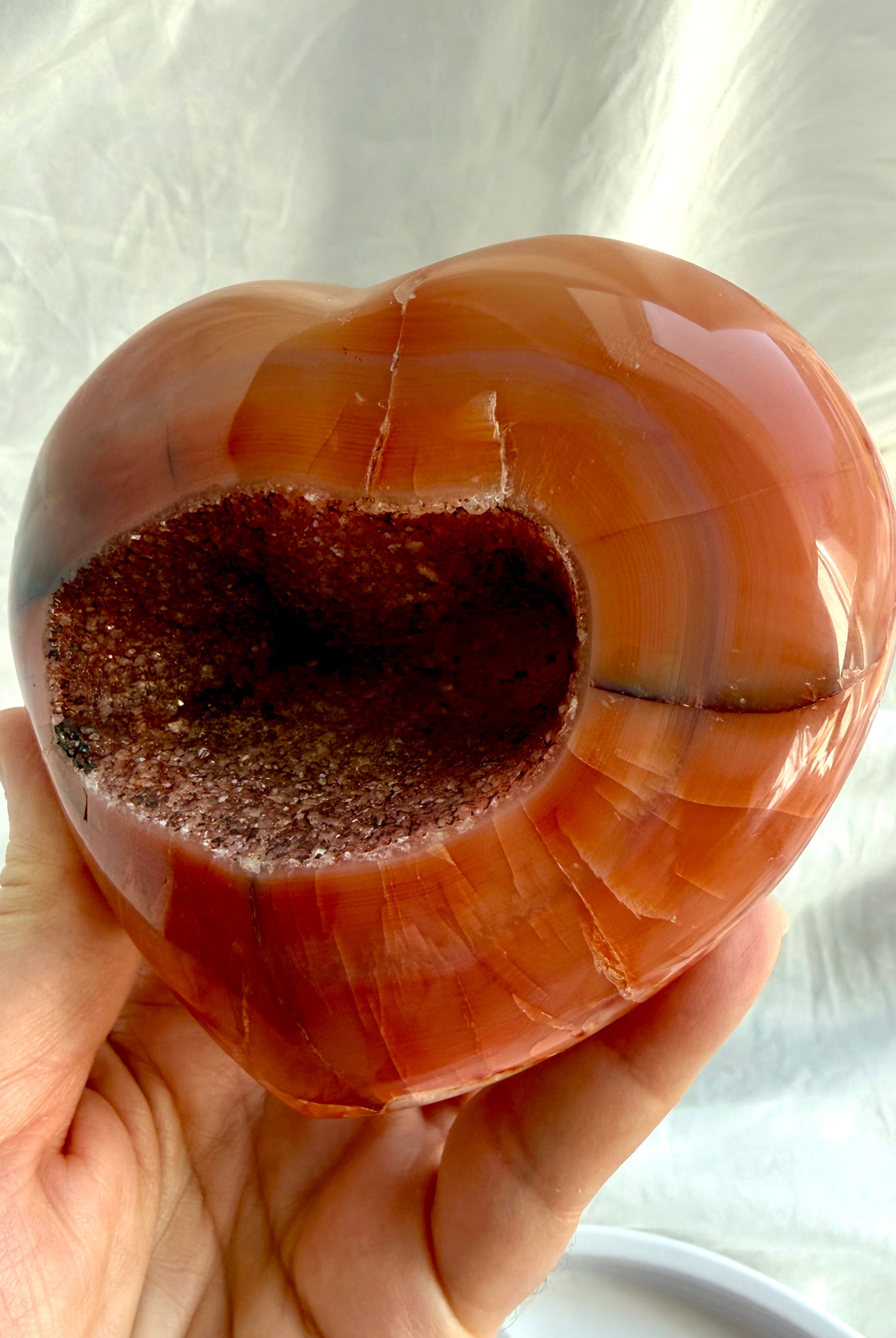 Opposite side of one of a kind Carnelian geode heart with polished red-orange patterns
