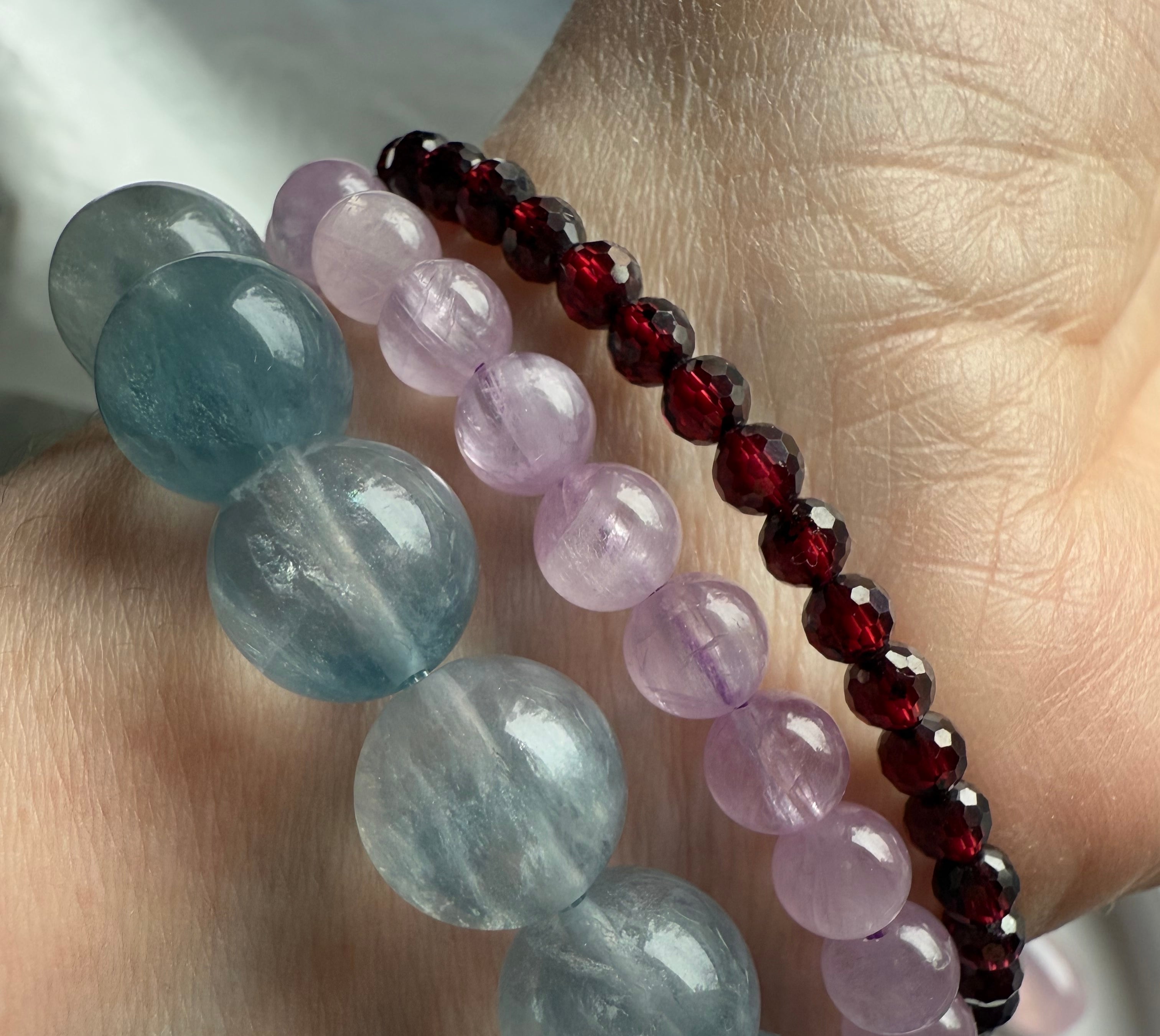 High quality faceted Almandine Garnet bracelet worn with Kunzite and silky blue fluorite bracelets