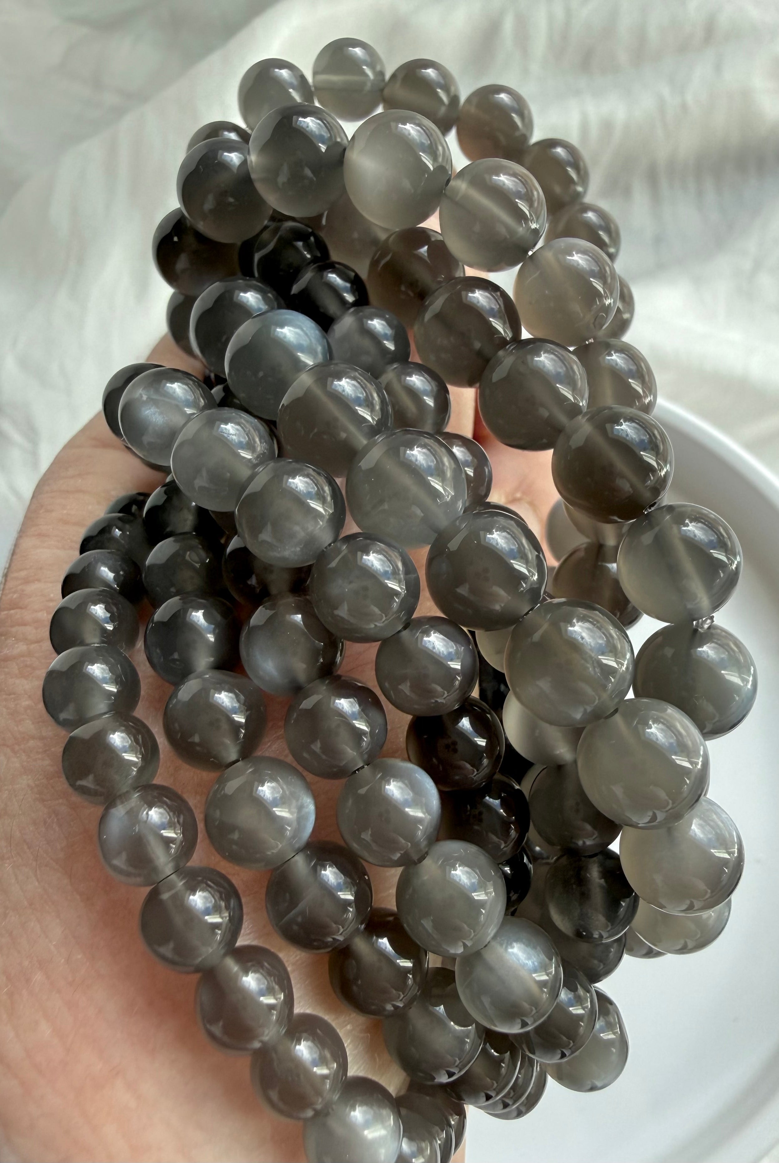 Natural Black Moonstone bracelets showing luminous adularescence and polished inky charcoal gemstone beads