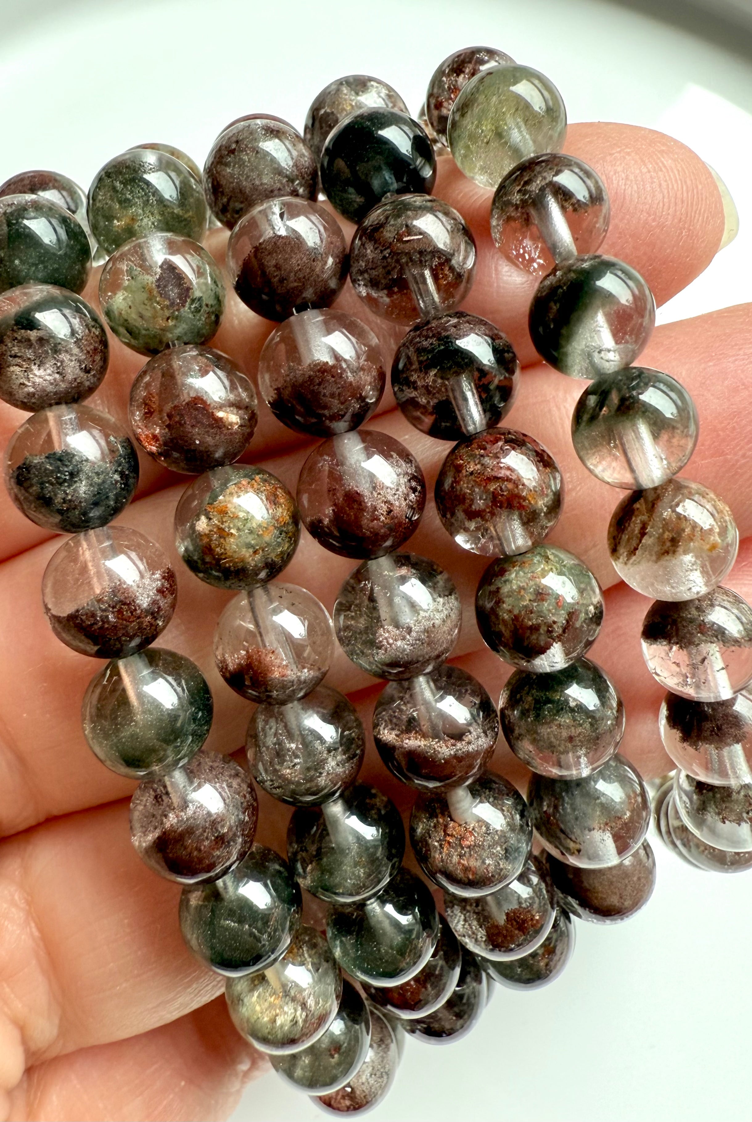 Garden Quartz bracelets with earthy, forest-toned inclusions and high-polish finish, close-up