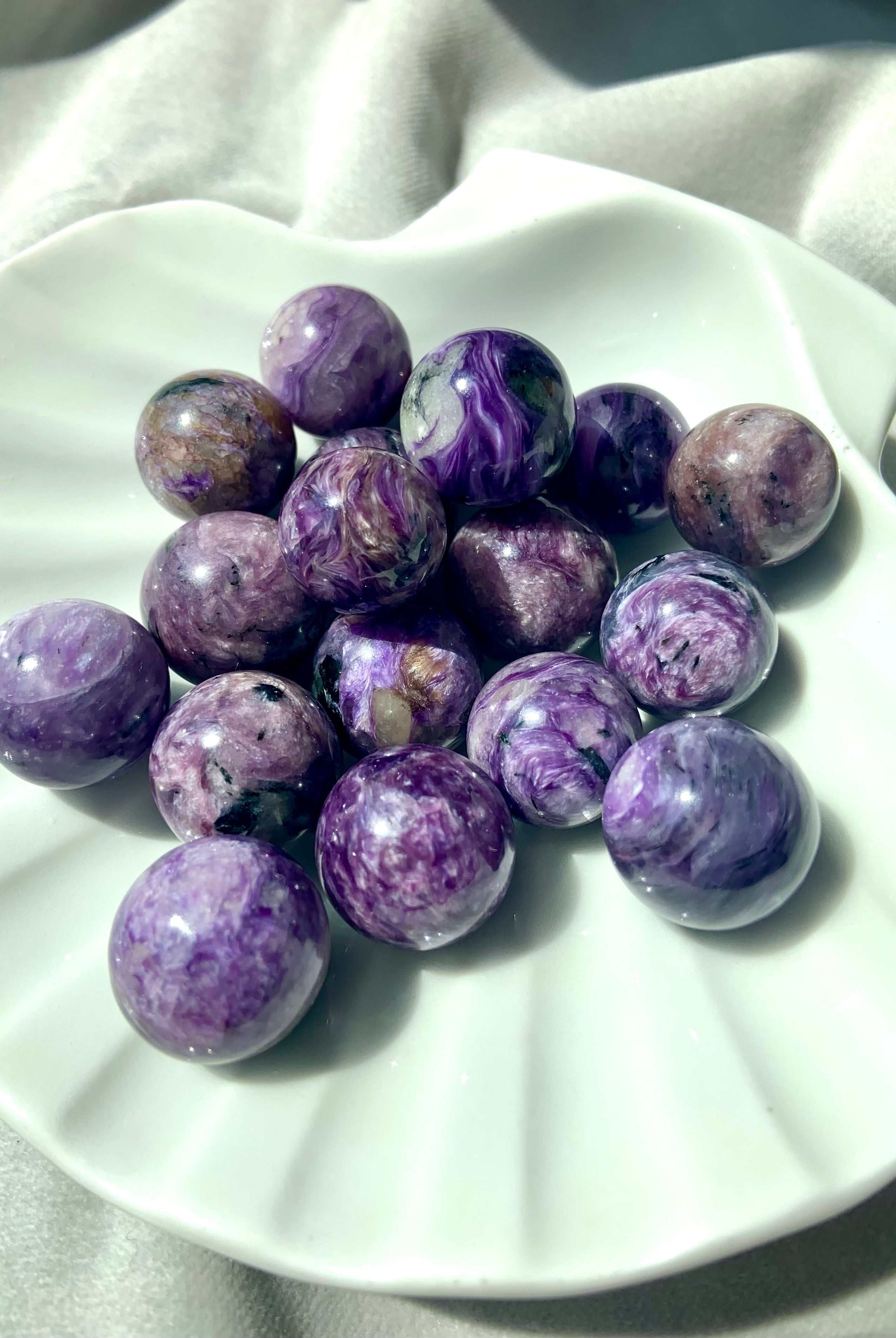 These rare mini Russian Charoite spheres have shimmering patterns in the stone.