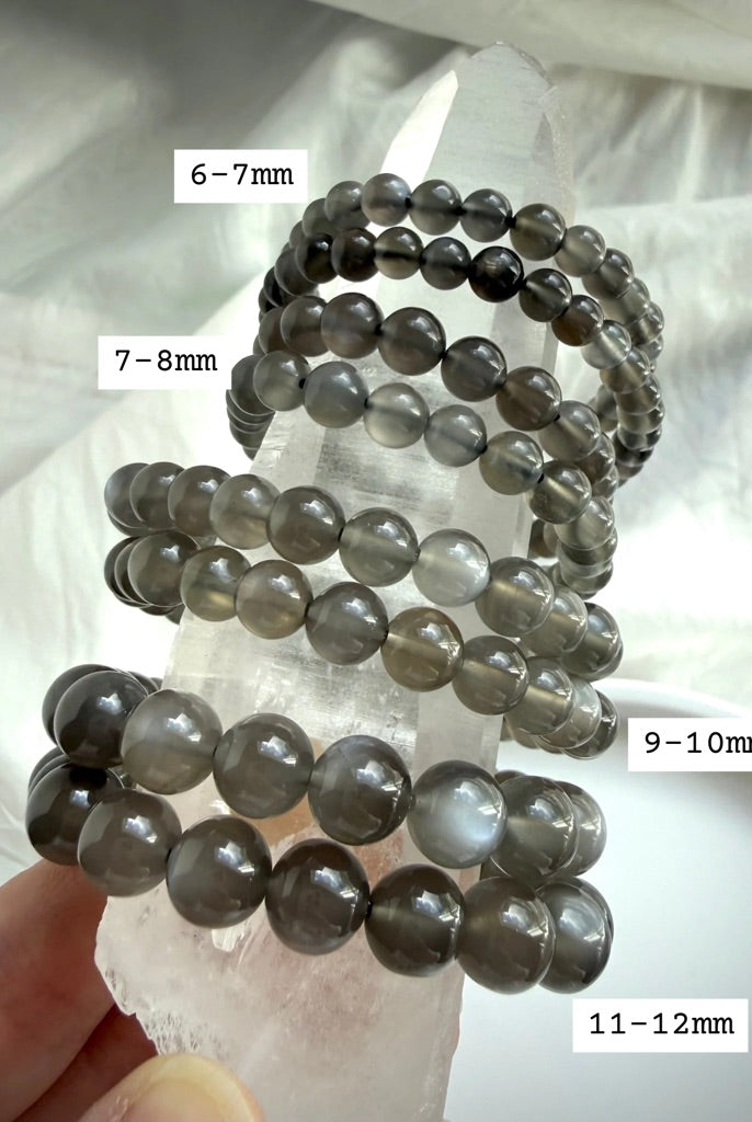 Black Moonstone bracelet size comparison displayed on Clear Quartz showing available 6–12 mm bead sizes