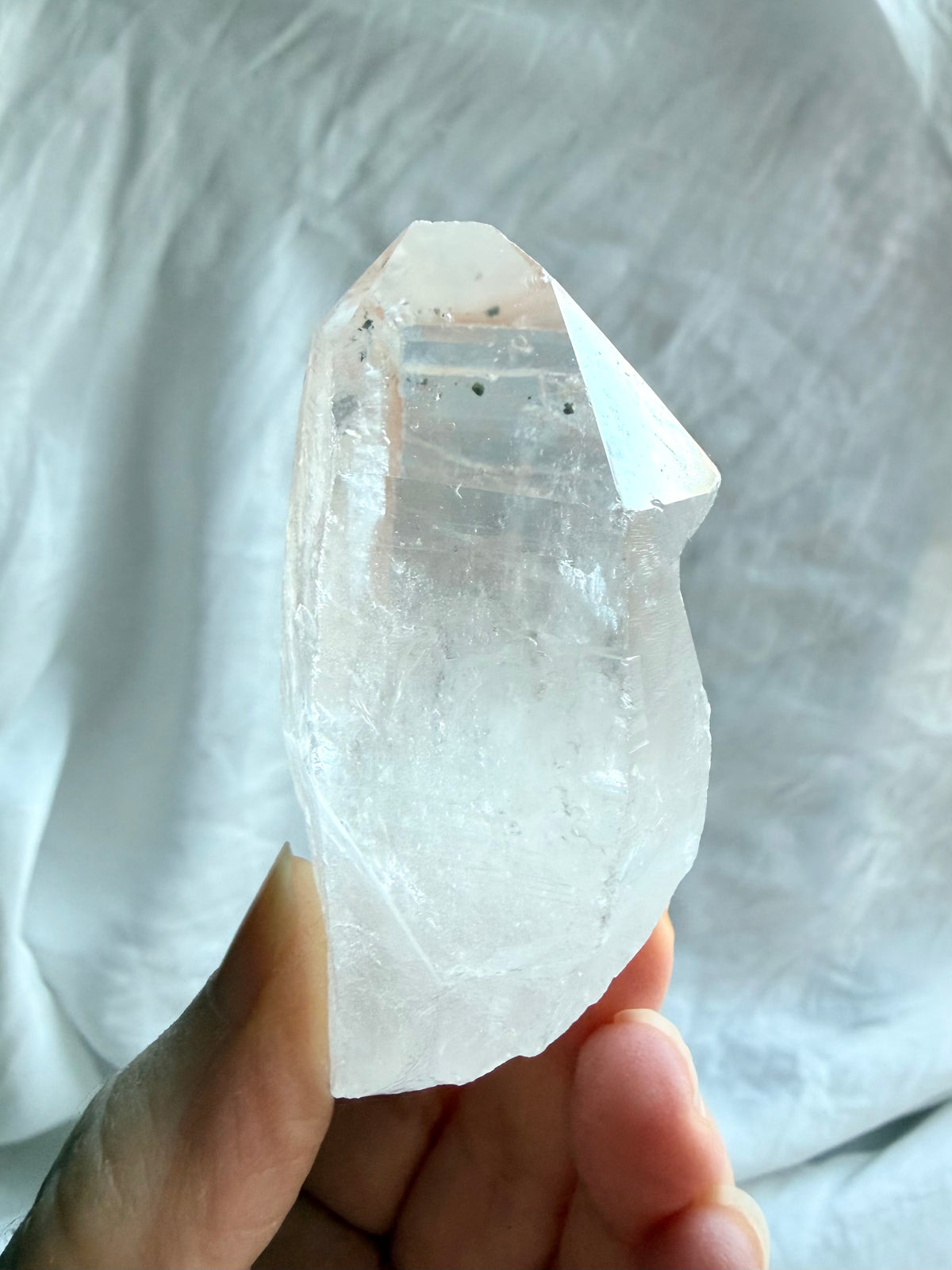 Chunky Clear Quartz point from Brazil with Lemurian ladder lines, natural inclusions, and a broad crystal termination